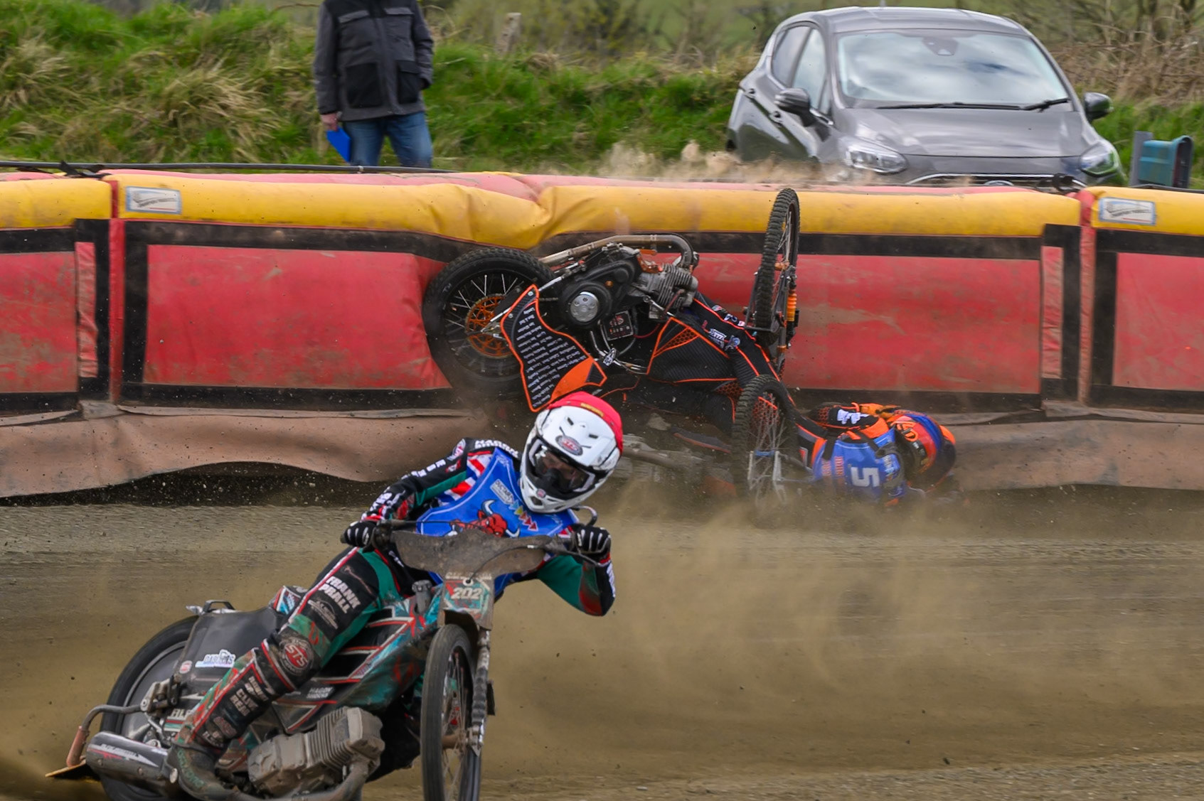 Connor Coles of NDL Nomads   in White fall and Jack Smith of Buxton Bulls   in Blue collides with him during the  Challenge match between Buxton Bulls and NDL Nomads at Hi-Edge Speedway, Buxton on Sunday 19th April 2026. (Photo: Ian Charles | MI News)