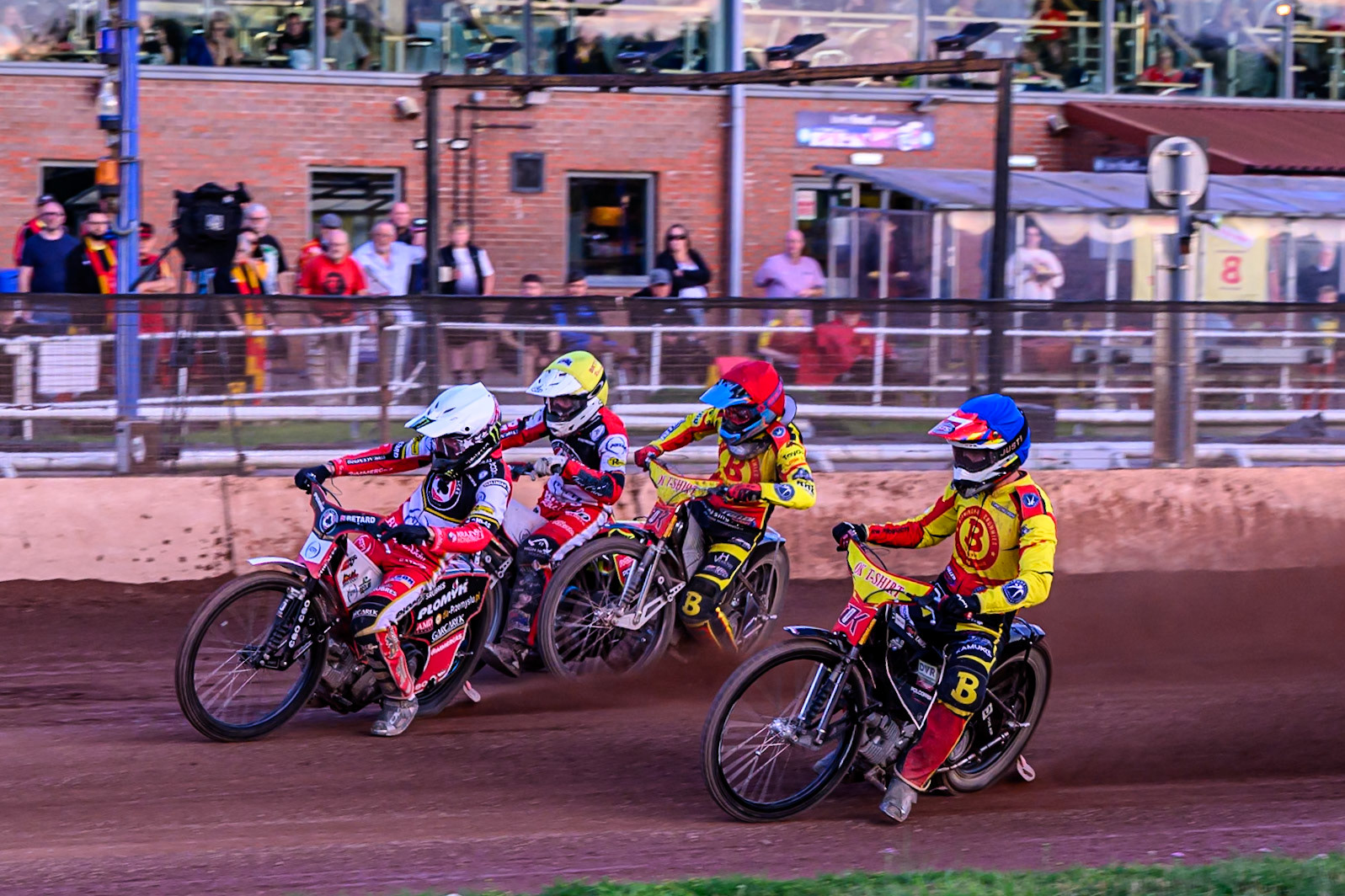Belle Vue Aces' Dan Bewley  in White leading Birmingham Brummies' Jonas Jeppesen  in Red, Birmingham Brummies' Keynan Rew  in Blue and Belle Vue Aces' Tate Zischke  in Yellow away from the start during the Rowe Motor Oil Premiership match between Birmingham Brummies and Belle Vue Aces at Perry Barr Stadium, Birmingham on Monday 28th July 2025. (Photo: Ian Charles | MI News)