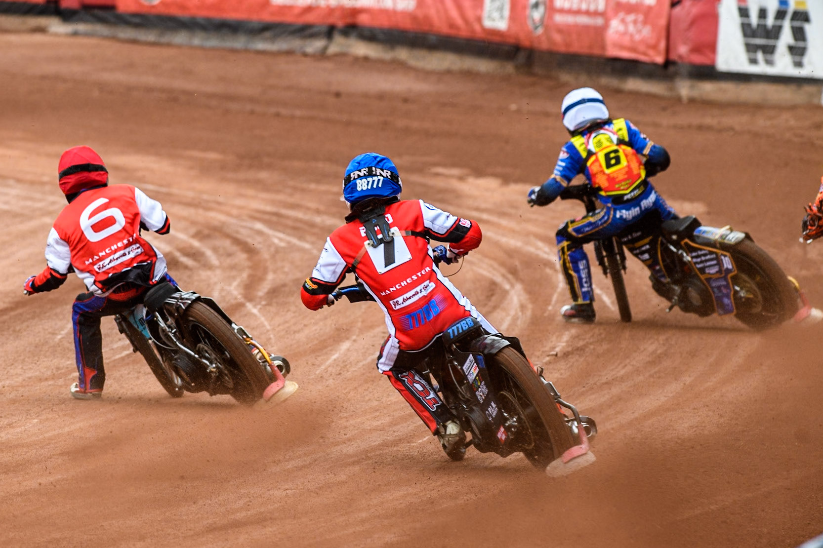 Belle Vue Colts' Billy Budd in Blue chases Belle Vue Colts' Harry Fletcher in Red and Leicester Lion Cubs' Cooper Rushen in Yellow during the WSRA National Development League match between Belle Vue Colts and Leicester Lion Cubs at the National Speedway Stadium, Manchester on Friday 18th April 2025. (Photo: Ian Charles | MI News)