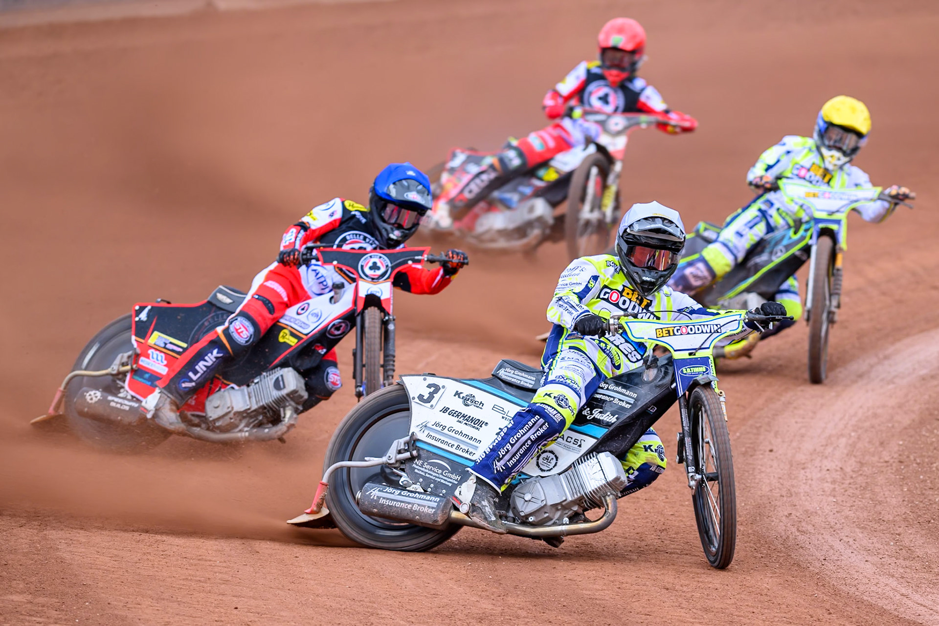 Oxford Spires' Erik Riss in White leading Belle Vue Aces' Zach Cook in Blue, Oxford Spires' Rohan Tungate in Yellow and Belle Vue Aces' Jaimon Lidsey in Red during the Rowe Motor Oil Premiership match between Belle Vue Aces and Oxford Spires at the National Speedway Stadium, Manchester on Monday 26th May 2025. (Photo: Ian Charles | MI News)