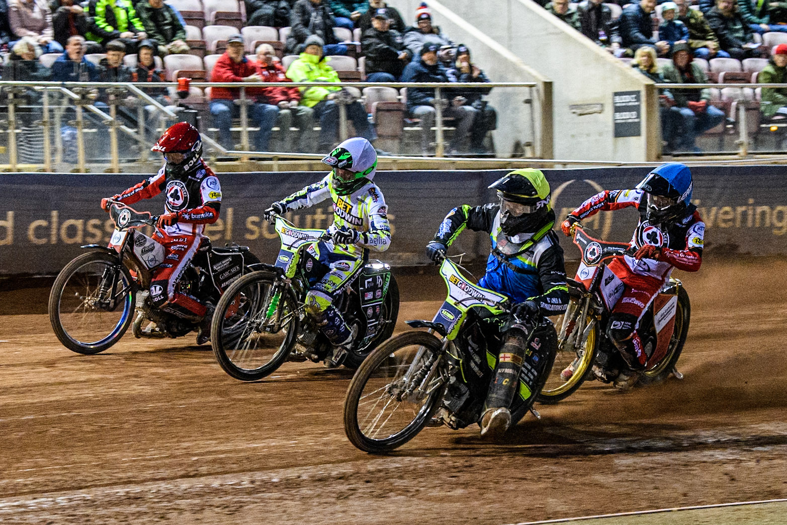 Oxford Spires' Guest Rider Dan Thompson in Yellow rides inside Oxford Spires' Charles Wright in White Belle Vue Aces' Brady Kurtz in Red with Belle Vue Aces' Norick Blodorn in Blue behind during the Rowe Motor Oil Premiership match between Belle Vue Aces and Oxford Spires at the National Speedway Stadium, Manchester on Monday 14th April 2025. (Photo: Ian Charles | MI News)