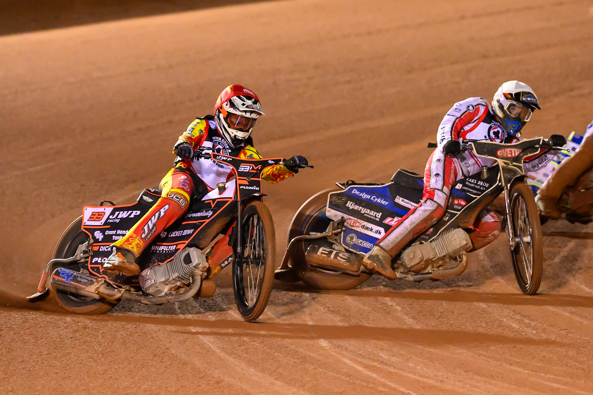 Sam Masters  in Red rides outside Rasmus Jensen  in White during the Peter Craven Memorial Trophy at the National Speedway Stadium, Manchester, on Monday 16th March 2026. (Photo: Ian Charles | MI News)