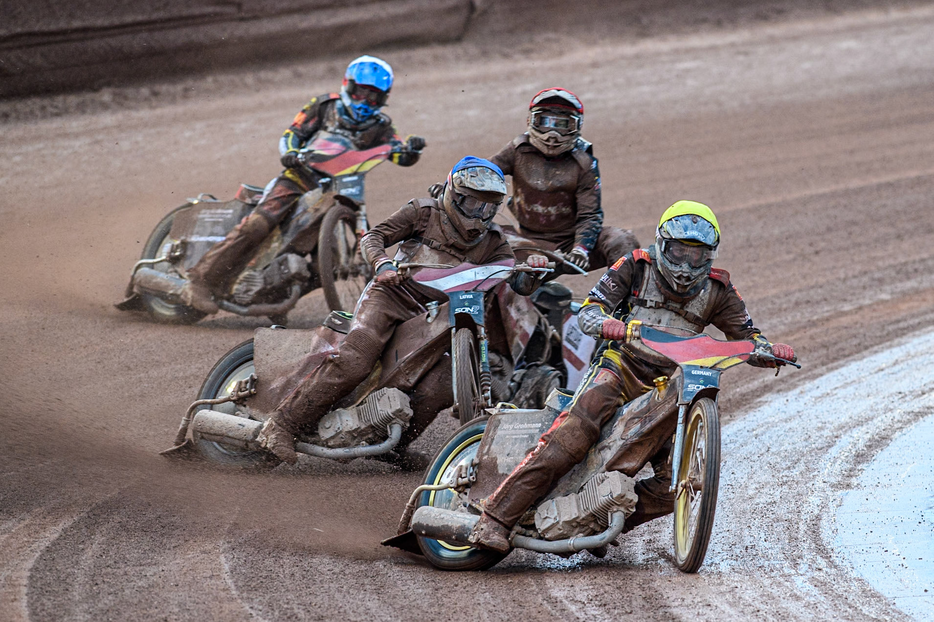 Norick Blödorn of Germany in Yellow leading Nikita Kaulins of Latvia in Blue as Artjoms Juhno of Latvia in Red picks up some drive ahead of Patrick Hyjek of Germany in White during the Monster Energy FIM Speedway of Nations 2 (Under 21) Final at the National Speedway Stadium, Manchester on Friday 12th July 2024. (Photo: Ian Charles | MI News)