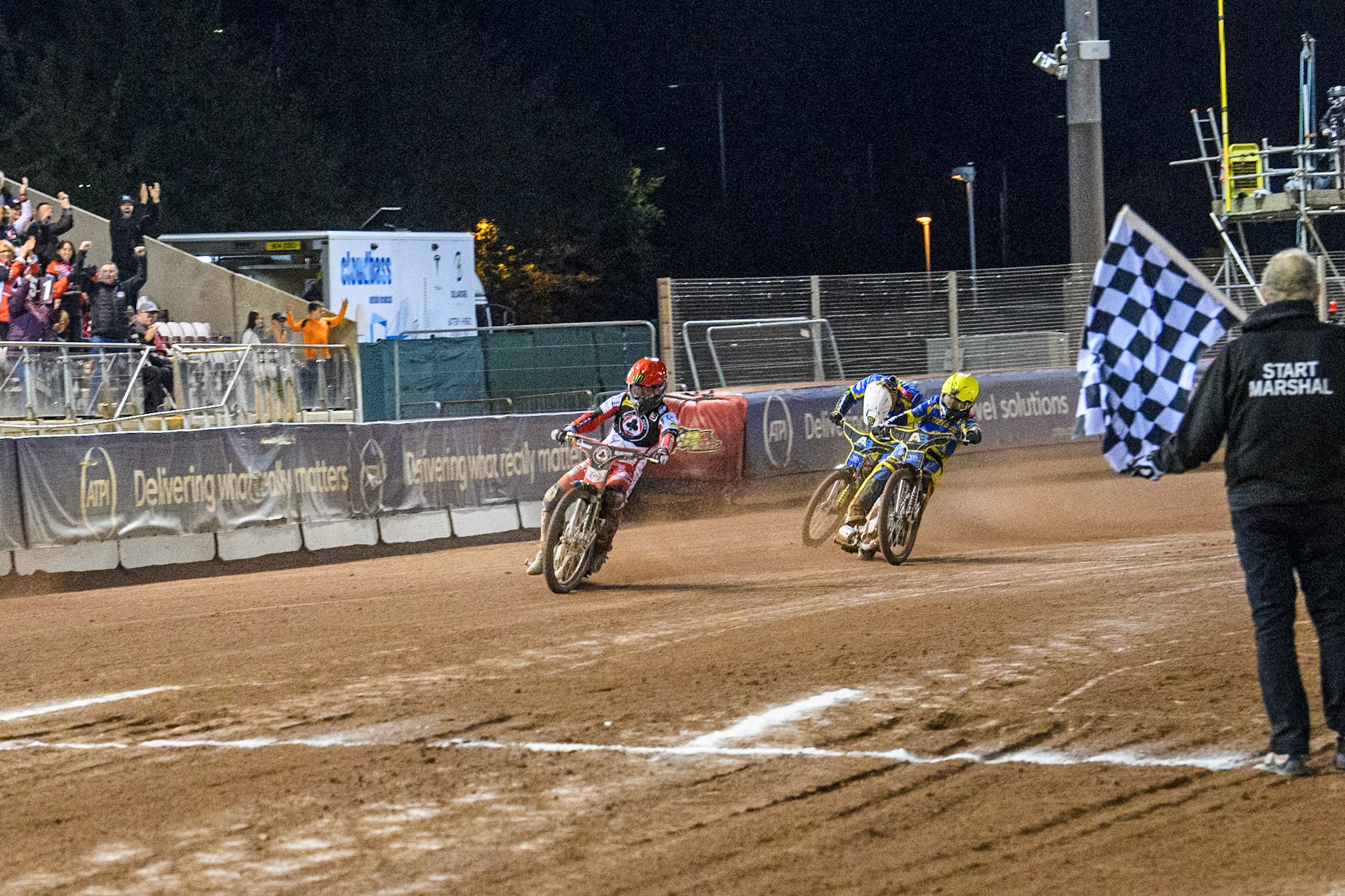 Belle Vue Aces' Jaimon Lidsey  leading Sheffield Tigers' Jack Holder  in Yellow and Sheffield Tigers' Chris Holder  in White over the finish line  during the Rowe Motor Oil Premiership Play Off Semi Final 2, 1st Leg match between Belle Vue Aces and Sheffield Tigers at the National Speedway Stadium, Manchester on Monday 16th September 2024. (Photo: Ian Charles | MI News)