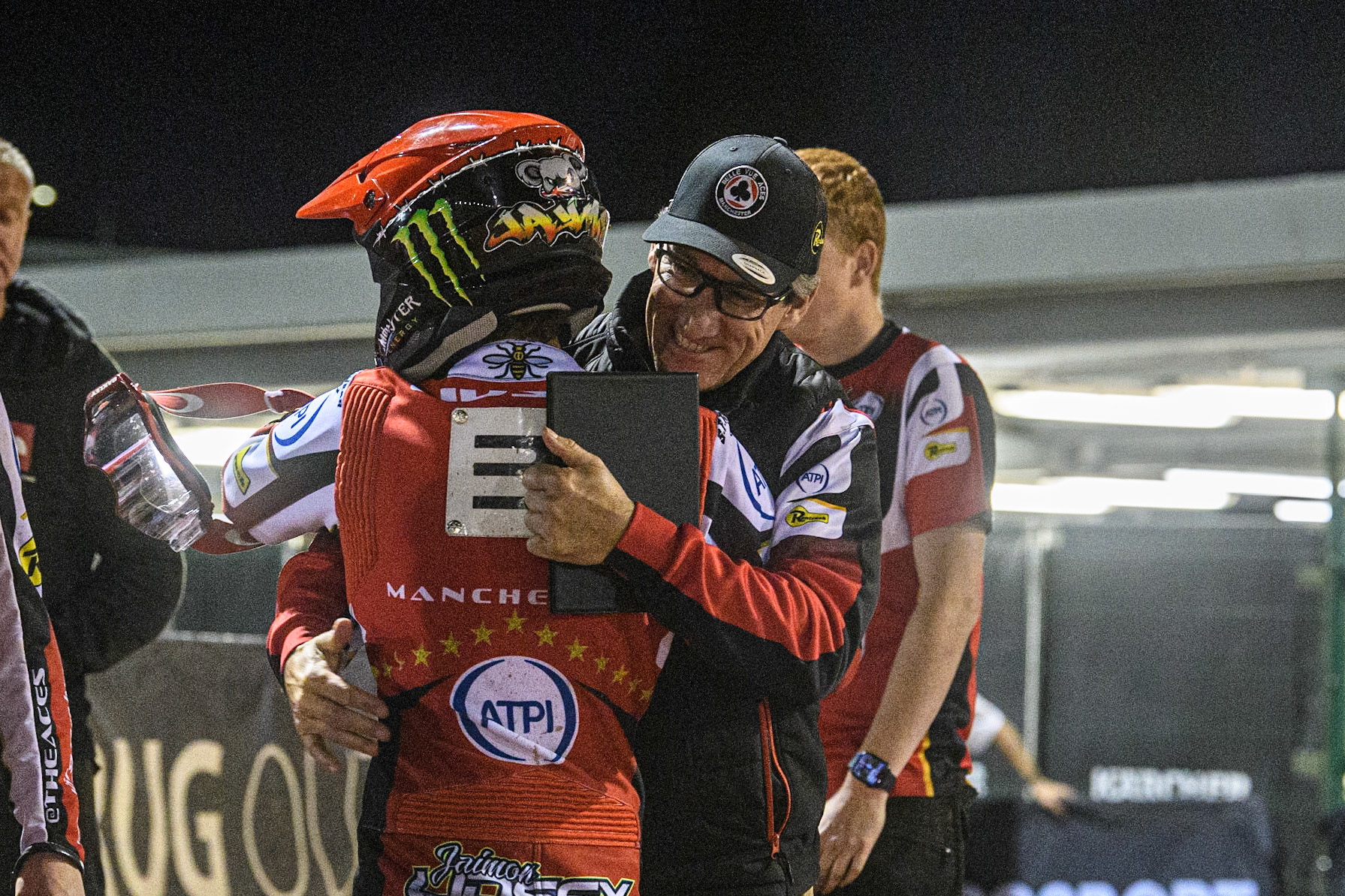 Adam Ellis is congratulated by Team Manager Mark Lemon during the Sports Insure Premiership match between Belle Vue Aces and Sheffield Tigers at the National Speedway Stadium, Manchester on Monday 7th August 2023. (Photo: Ian Charles | MI News)