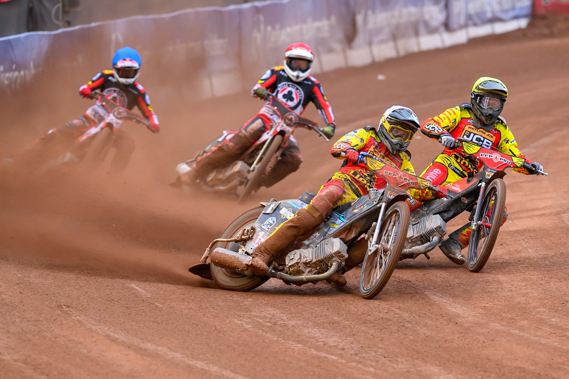 Ryan Douglas of Leicester Lions in White leading Dan Thompson of Leicester Lions in Yellow, Zach Cook of Belle Vue Aces in Blue and Peter Kildemand of Belle Vue Aces in Red during the Rowe Motor Oil Premiership match between Belle Vue Aces and Leicester Lions at the National Speedway Stadium, Manchester on Monday 15th June 2026. (Photo: Ian Charles | MI News)