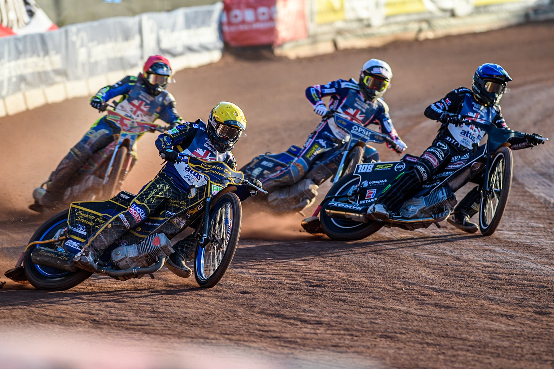 Kyle Howarth in Yellow rides outside Tai Woffinden in Blue with Simon Lambert in Red and Anders Rowe in White behind during the Attis Insurance Sports Division British Speedway Championship Final at the National Speedway Stadium, Manchester on Saturday 8th June 2024. (Photo: Ian Charles | MI News)
