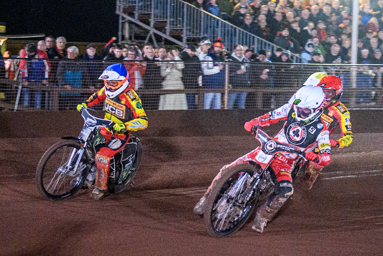 Belle Vue Aces' Dan Bewley in White rides inside Leicester Lions' Richard Lawson in Blue with Leicester Lions' Max Fricke in Red and Belle Vue Aces' Antti Vuolas in Yellow behind during the Rowe Motor Oil Premiership Grand Final 2nd Leg between Leicester Lions and Belle Vue Aces at the Pidcock Motorcycles Arena, Leicester on Thursday 26th September 2024. (Photo: Ian Charles | MI News)
