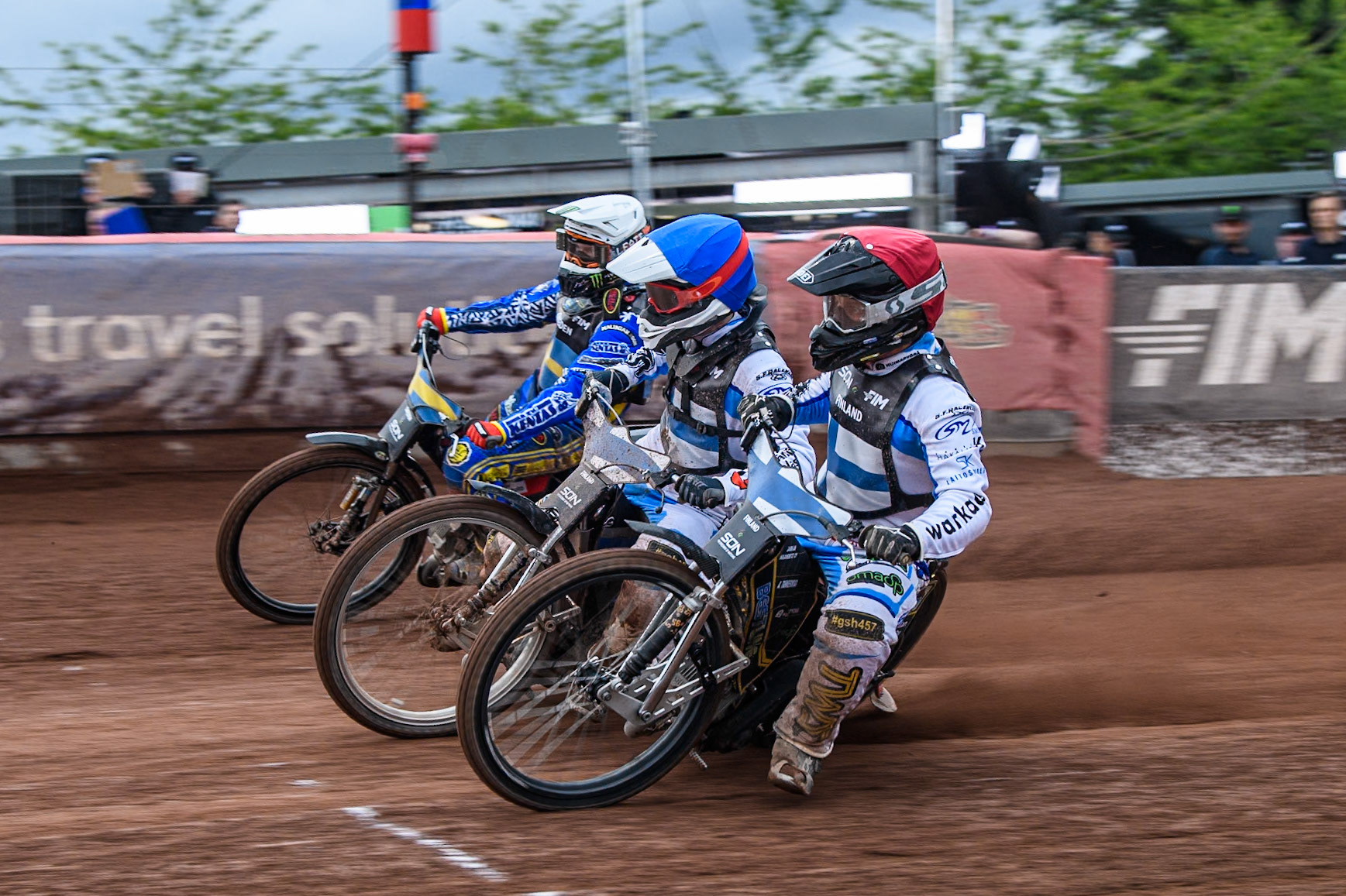 Finland v Sweden: Jesse Mustonen of Finland in Red rides inside Antti Vuolas of Finland and Fredrik Lindgren of Sweden in White during the Monster Energy FIM Speedway of Nations Semi-Final 1 at the National Speedway Stadium, Manchester on Tuesday 9th July 2024. (Photo: Ian Charles | MI News)