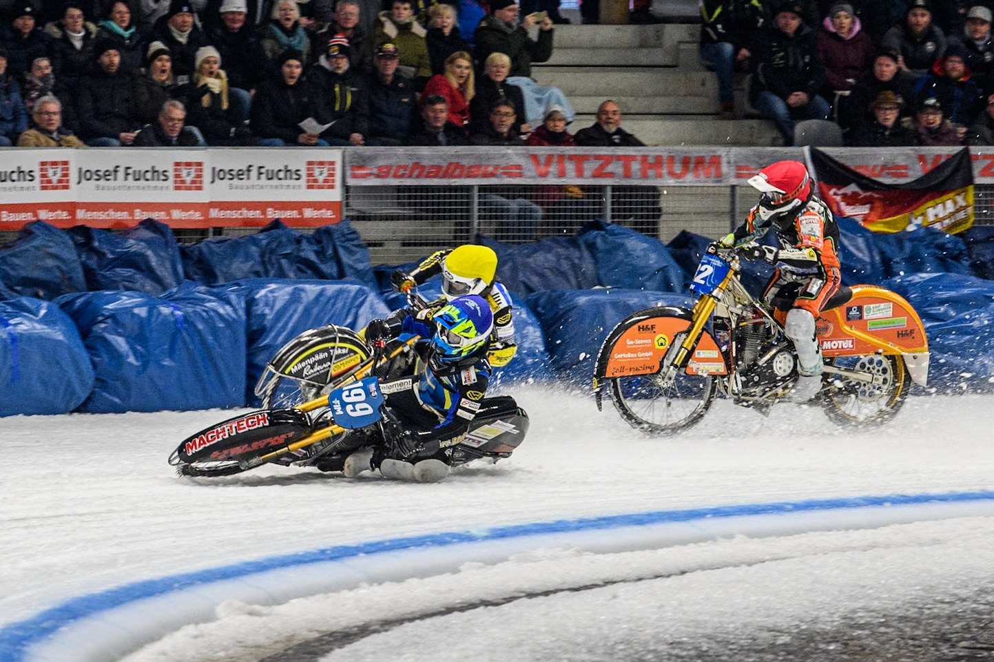 Sweden's Martin Haarahiltunen (199)  (Blue) leads  and Germany's Markus Jell (82) (Red) and Finland's Heikki Huusko (67)y\ collide and crash into the bales during the FIM Ice Speedway Gladiators World Championship Final 2 at the Max-Aicher-Arena, Inzell on Sunday 24 March 2024. (Photo: Ian Charles | MI News)