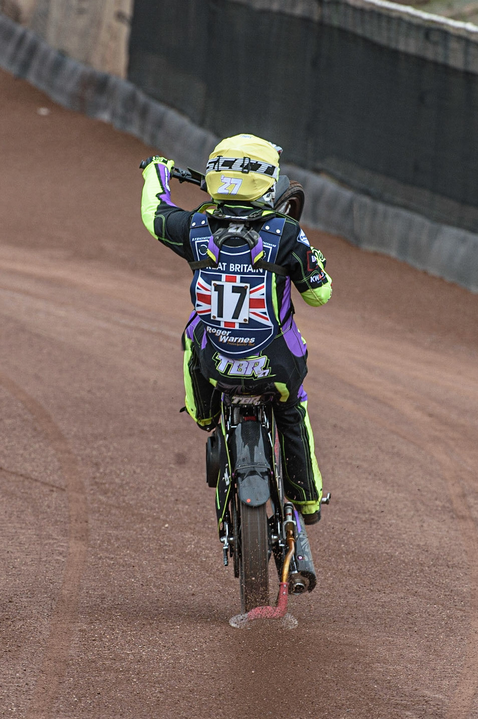 GLASGOW, UK. JUNE 19TH.  Tom Brennan (Reserve) (Great Britain)celebrates his second place in heat 1 with a wheelie during the FIM Speedway Grand Prix Qualifying Round at the Peugeot Ashfield Stadium, Glasgow on Saturday 19th June 2021. (Credit: Ian Charles | MI News)