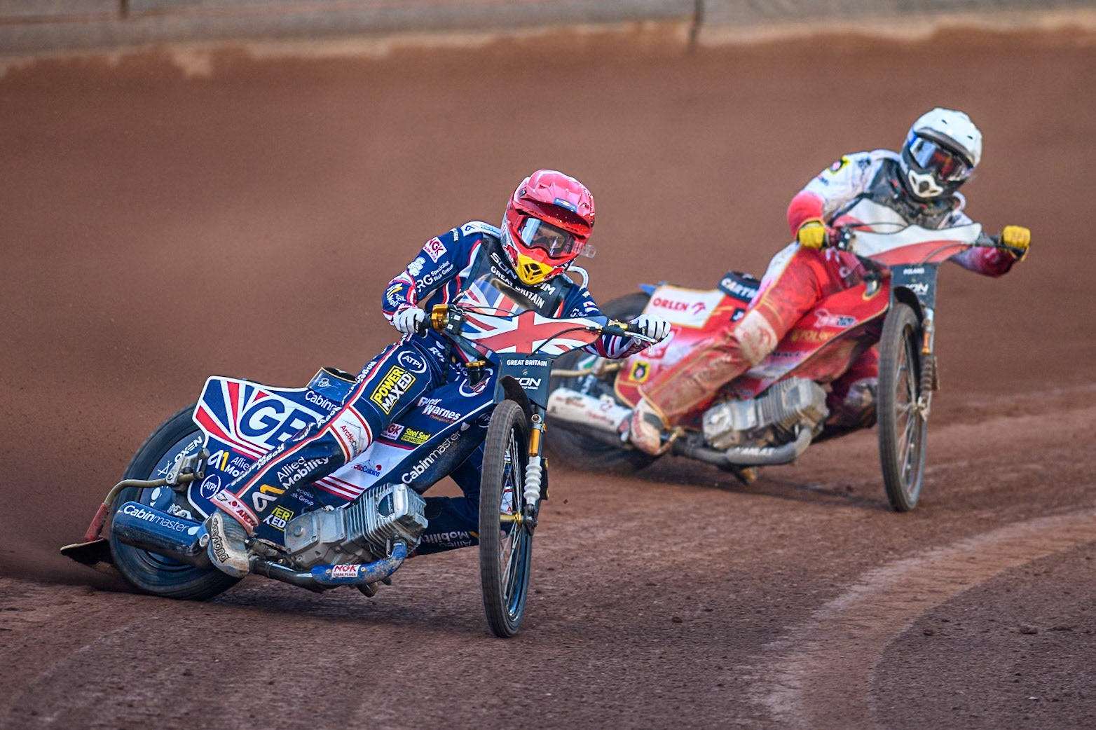 Robert Lambert of Great Britain in Red leading Dominik Kubera of Poland in White during the Monster Energy FIM Speedway of Nation Final at the National Speedway Stadium, Manchester on Saturday 13th July 2024. (Photo: Ian Charles | MI News)