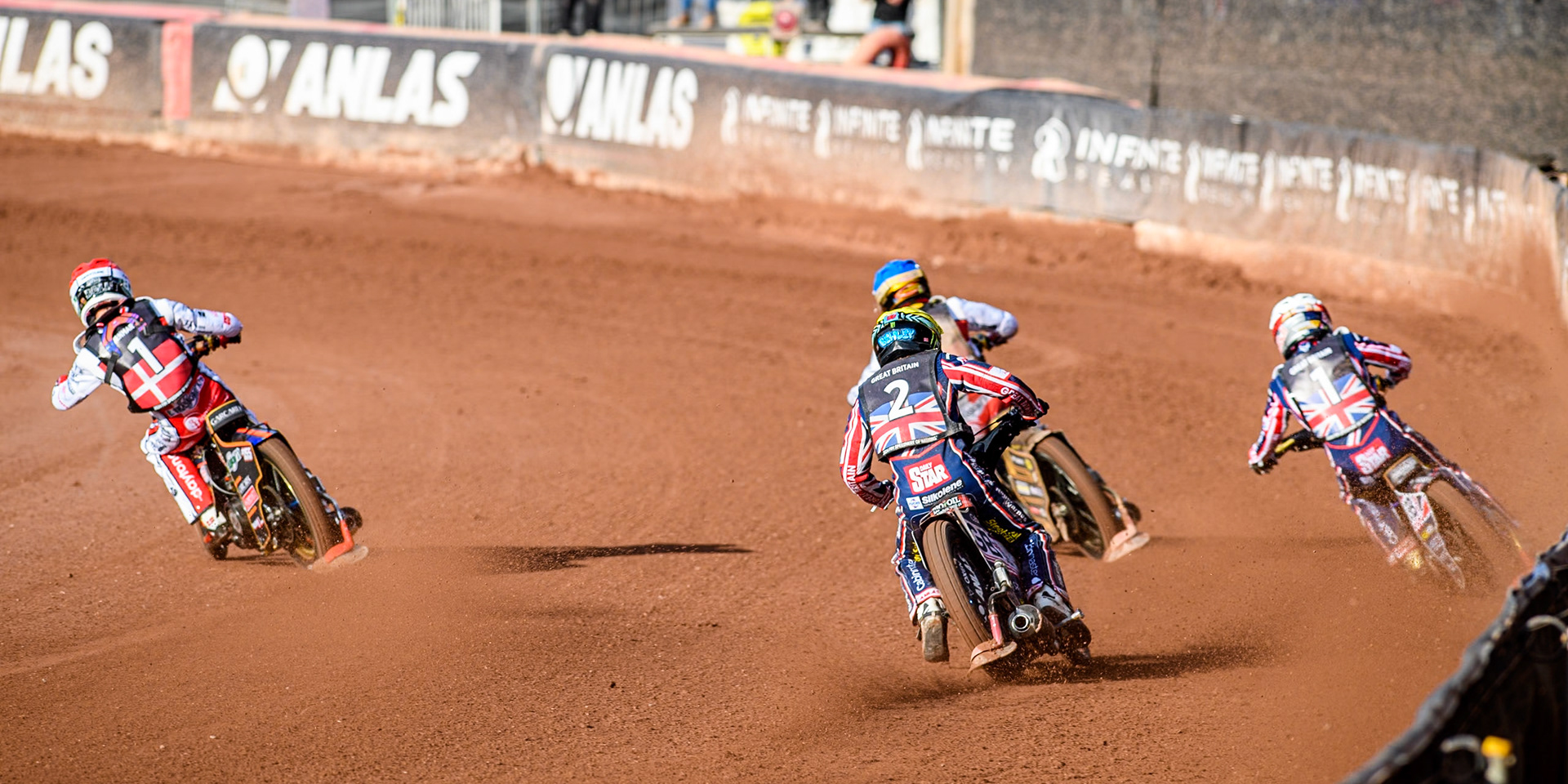 Dan Bewley of Great Britain in Yellow chases Mikkel Michelsen of Denmark in Red, Anders Thomsen of Denmark in Blue and Robert Lambert of Great Britain in White during the Monster Energy FIM Speedway of Nation Final at the National Speedway Stadium, Manchester on Saturday 13th July 2024. (Photo: Ian Charles | MI News)
