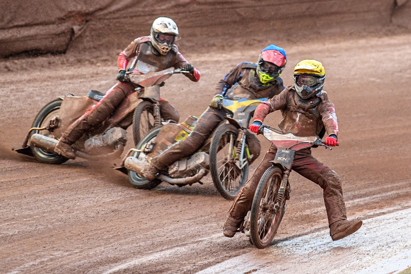 Bartosz Banbor of Poland in Yellow gets out of shape leading Casper Henriksson of Sweden in Blue and Wiktor Przyjemski of Poland in White during the Monster Energy FIM Speedway of Nations 2 (Under 21) Final at the National Speedway Stadium, Manchester on Friday 12th July 2024. (Photo: Ian Charles | MI News)