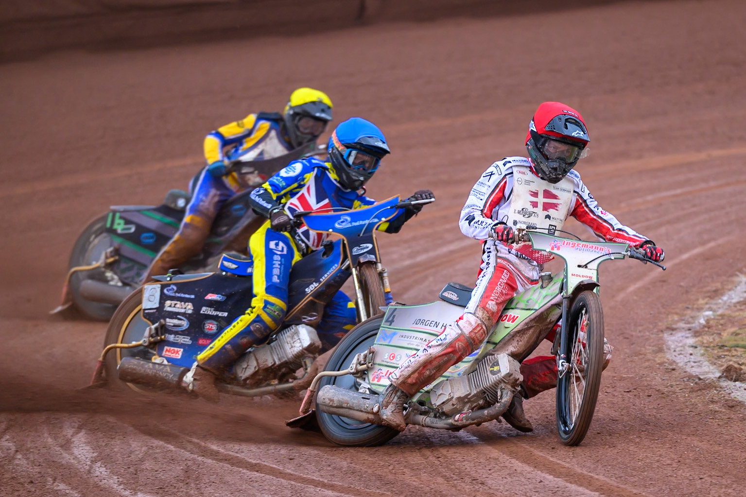 Jonas Knudsen of Denmark in Red leading Anders Rowe of Great Britain in Blue and Daniel Klima of Czechia in Yellow during the Speedway GP Qualifying Round 3 at Allied Ashfield Stadium, Glasgow on Saturday 30th May 2026. (Photo: Ian Charles | MI News)