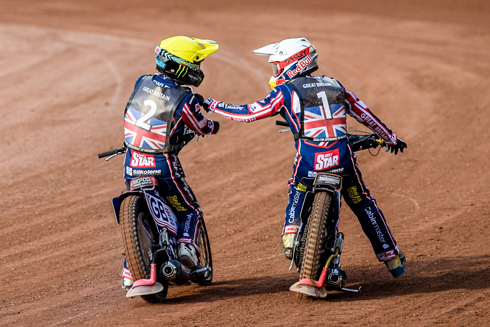 Dan Bewley of Great Britain in Yellow and Robert Lambert of Great Britain celebrate their maximum heat win during the Monster Energy FIM Speedway of Nation Final at the National Speedway Stadium, Manchester on Saturday 13th July 2024. (Photo: Ian Charles | MI News)