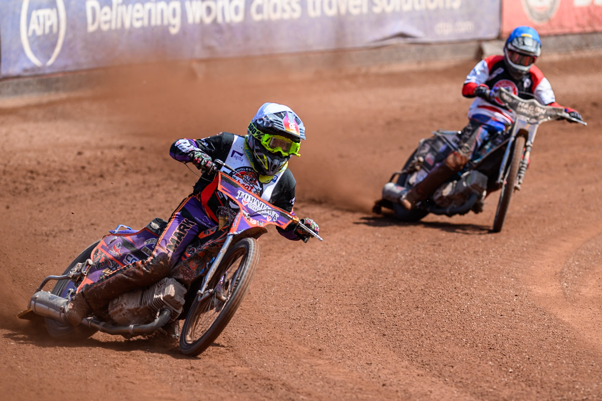 Elliot Kelly of Middlesborough Tigers  in White leading Harry Fletcher of Belle Vue Colts  in Blue during the WSRA National Development League match between Belle Vue Colts and Middlesbrough Tigers at the National Speedway Stadium, Manchester on Sunday 10th August 2025. (Photo: Mark Fletcher | MI News)