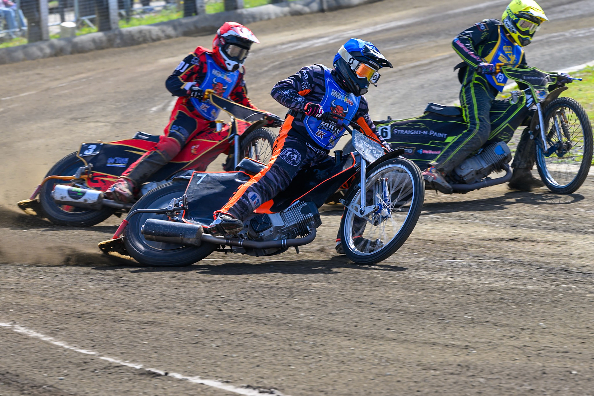Jack Roberts of Buxton Bulls in Blue rides outside Ben Whalley of Edinburgh Monarchs Academy in Yellow with Luke Harris of Buxton Bulls in Red behind during the WSRA National Development League match between Buxton Bulls and Edinburgh Monarchs Academy at Hi-Edge Speedway, Buxton on Sunday 14th June 2026. (Photo: Ian Charles | MI News)