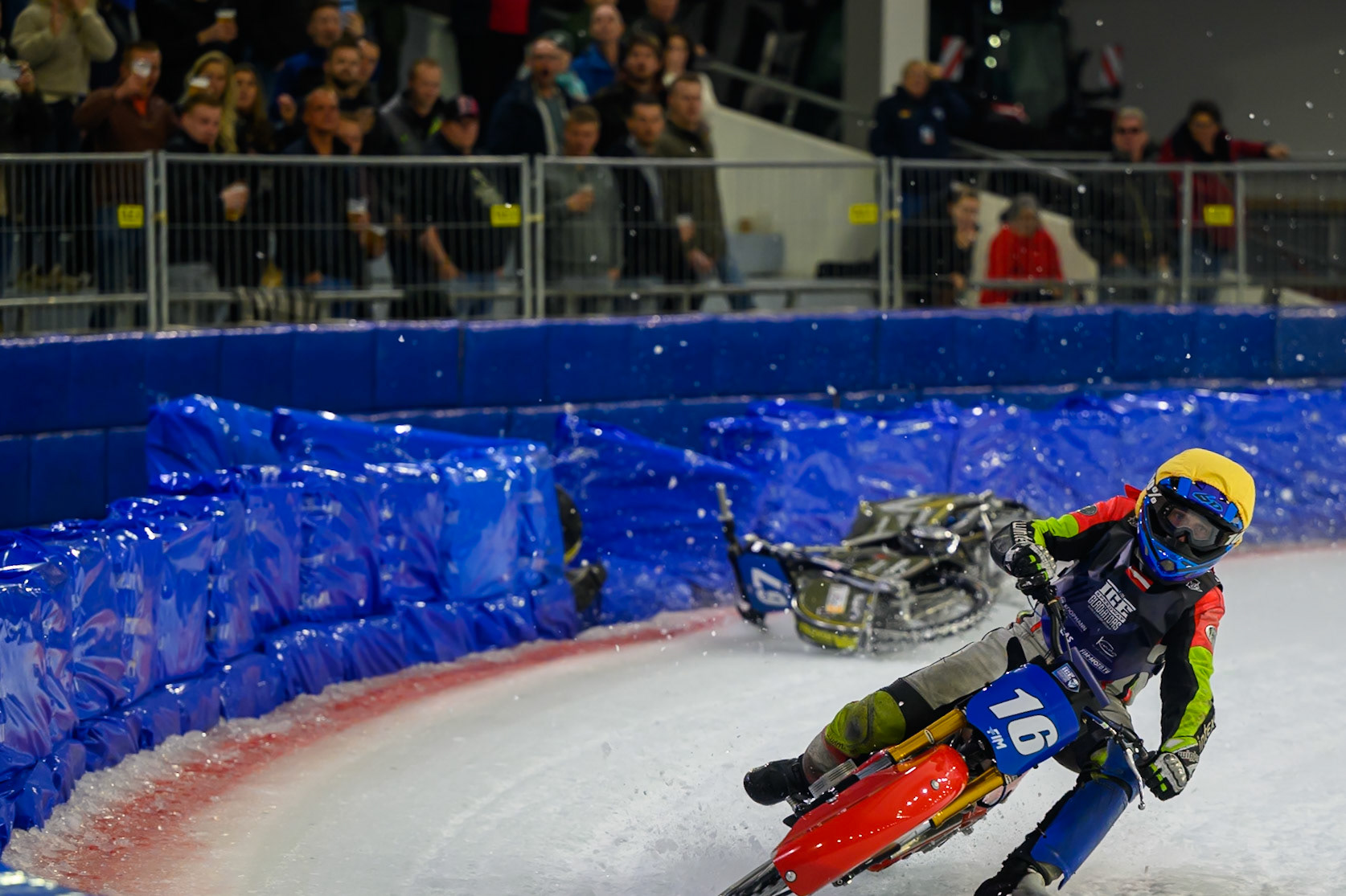 Heikki Huusko (67) of Finland  collides with Wild Card Harald Simon (16) of Austria in Yellow in the first turn during the FIM Ice Speedway Gladiators World Championship Final 3 at Ice Rink Thialf, Heerenveen on Saturday 11th April 2026. (Photo: Ian Charles | MI News)