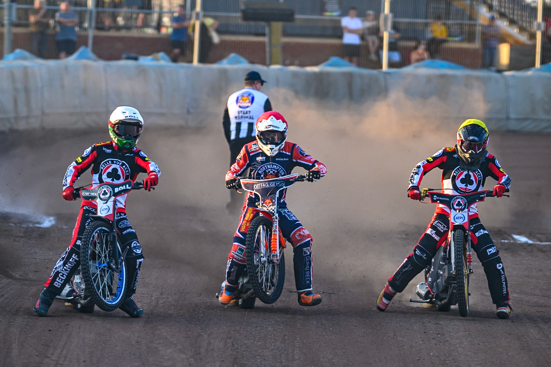 (L to R) Brady Kurtz of Belle Vue Aces  in White , Niels-Kristian Iversen of Northampton Foxes  in Red and Norick Blodorn of Belle Vue Aces  in Yellow head to the first turn during the Rowe Motor Oil Premiership match between Northampton Foxes and Belle Vue Aces at Northampton International Shaleway, Northampton on Thursday 13th August 2026. (Photo: Ian Charles | MI News)