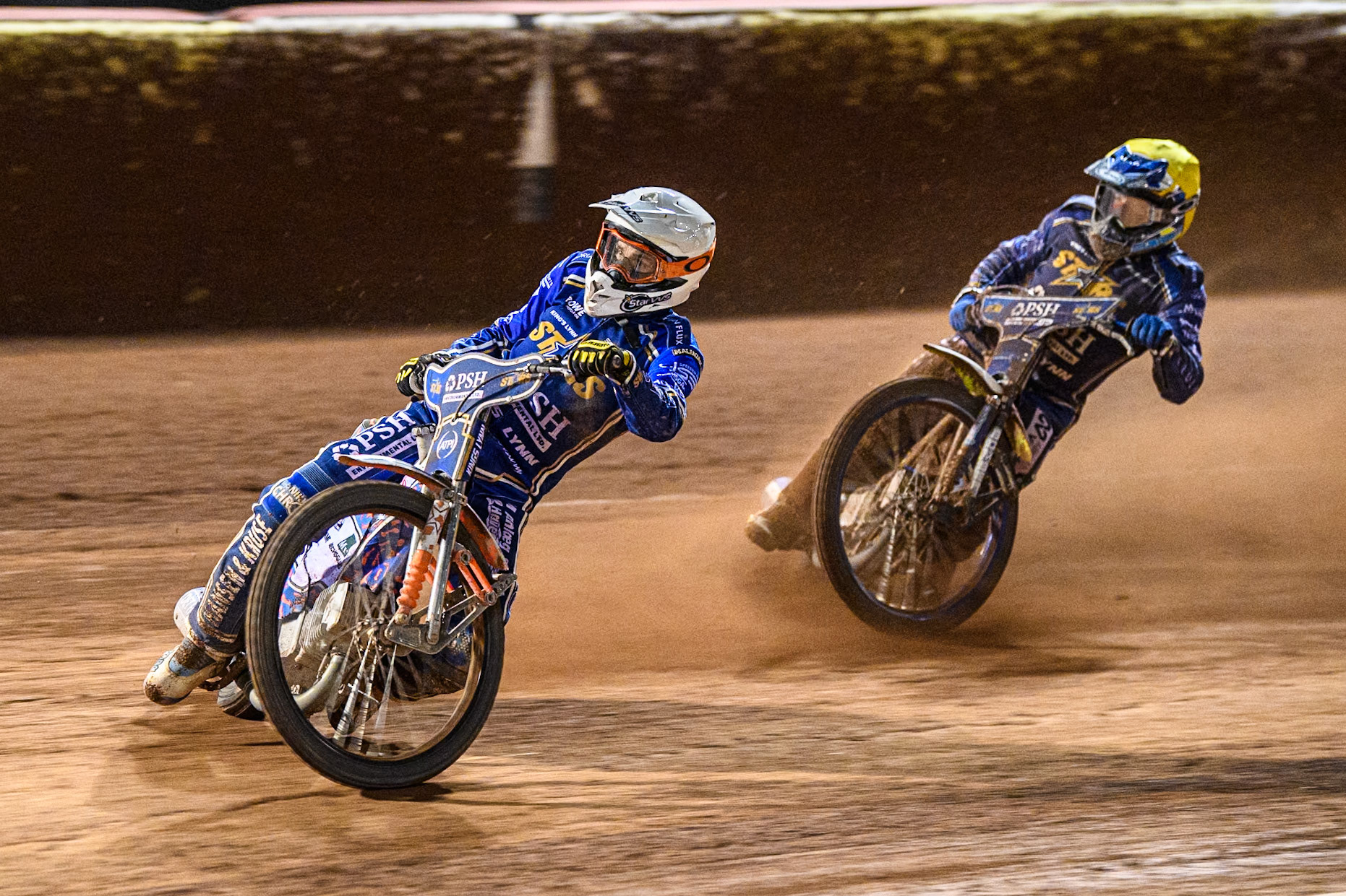 Niels-Kristian Iversen of Kings Lynn Stars in White leading team mate Chris Harris in Yellow during the Rowe Motor Oil Premiership match between Belle Vue Aces and King's Lynn Stars at the National Speedway Stadium, Manchester on Monday 5th April 2025. (Photo: Ian Charles | MI News)