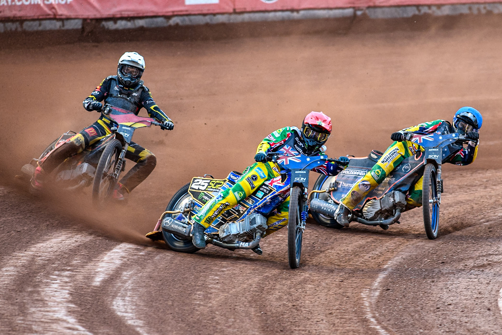 AUSTRALIA v GERMANY: Jack Holder of Australia in Red leading Brady Kurtz of Australia in Blue and Kai Huckenbeck of Germany in White during the Monster Energy FIM Speedway of Nation Final at the National Speedway Stadium, Manchester on Saturday 13th July 2024. (Photo: Ian Charles | MI News)