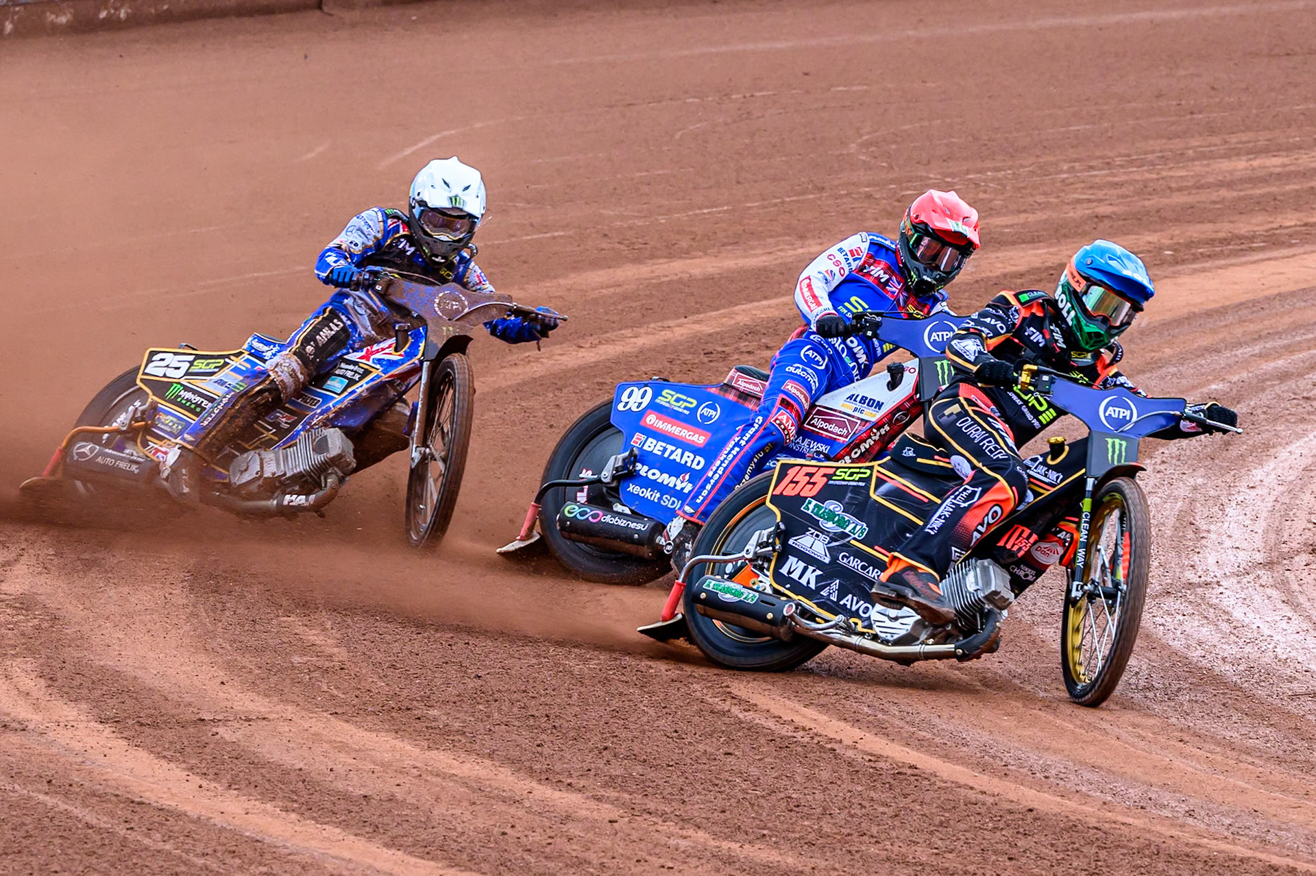 Mikkel Michelsen (155) of Denmark in Blue leading Dan Bewley (99) of Great Britain in Red and Jack Holder (25) of Australia in White during the ATPI FIM Speedway Grand Prix Round 4 at the National Speedway Stadium, Manchester, on Friday 13th June 2025. (Photo: Ian Charles | MI News)