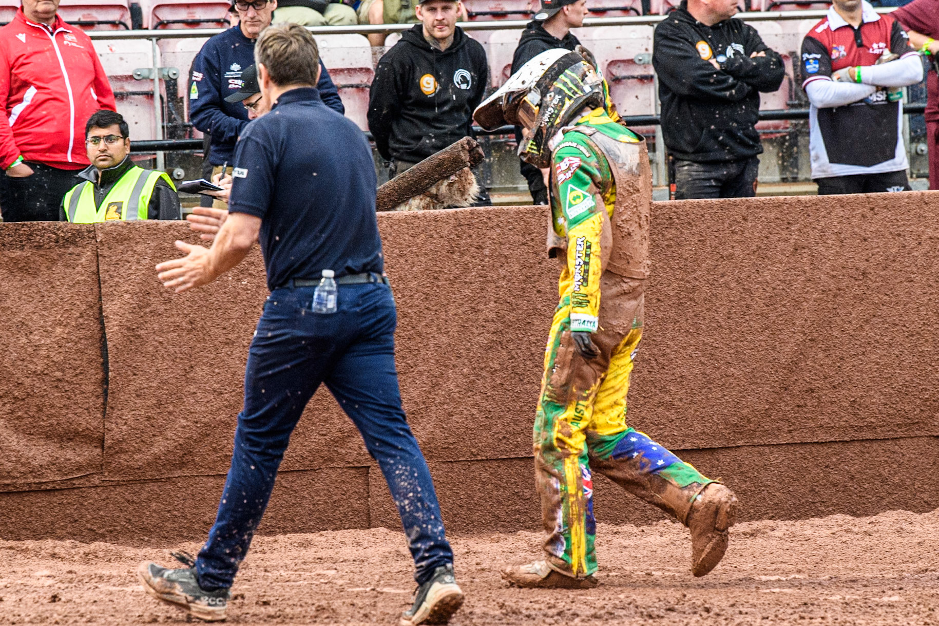 Jack Holder of Australia (Right) walks back to pits with race director Phil Morris during the Monster Energy FIM Speedway of Nation Semi Final 2 at the National Speedway Stadium, Manchester on Wednesday 10th July 2024. (Photo: Ian Charles | MI News)