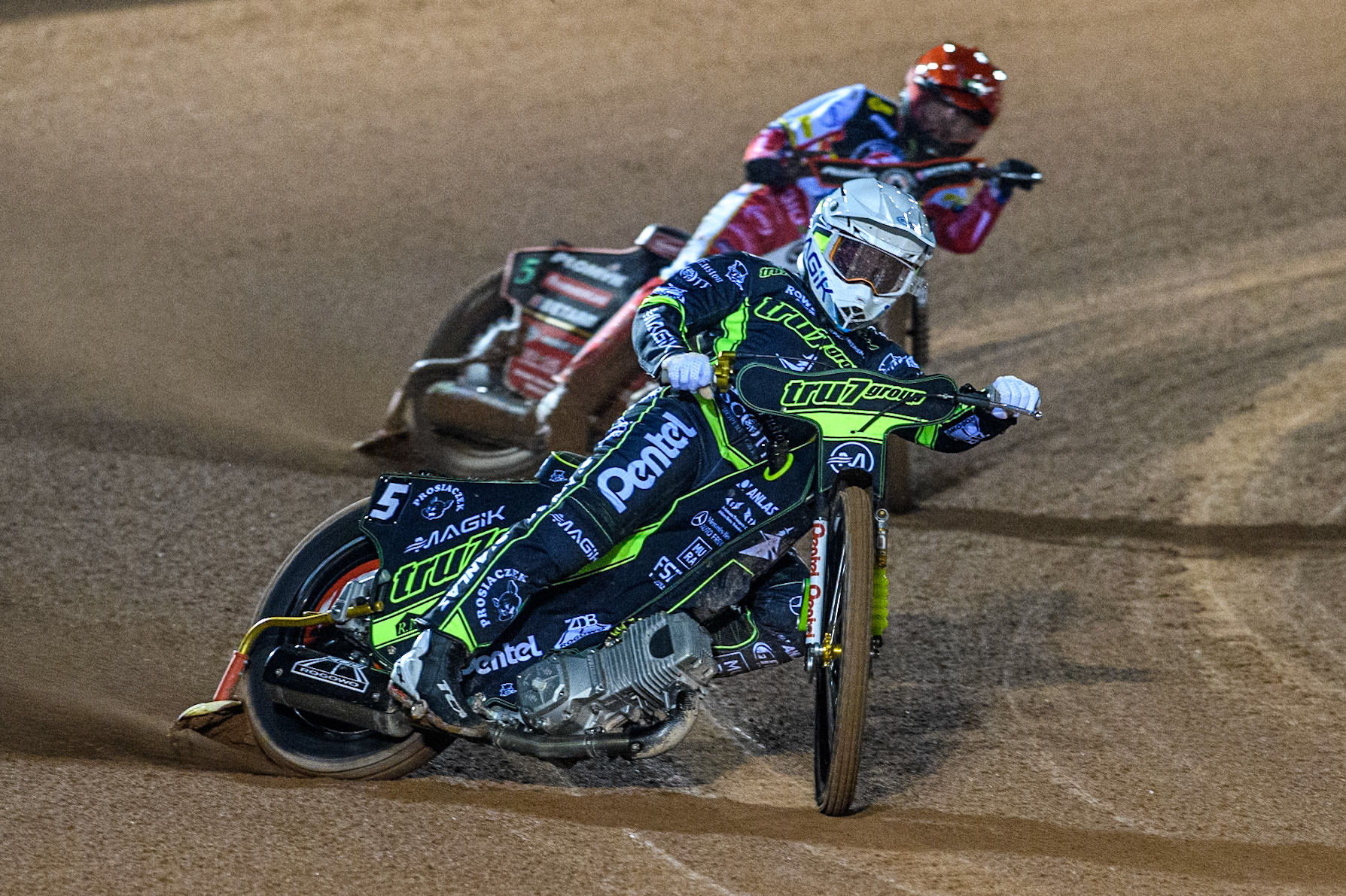 Emil Sayfutdinov of Ipswich Witches in White leading Dan Bewley of Belle Vue Aces in Red during the Premiership Cup Quarter Final 1st Leg match between Belle Vue Aces and Ipswich Witches at the National Speedway Stadium, Manchester on Monday 24th March 2025. (Photo: Ian Charles | MI News)