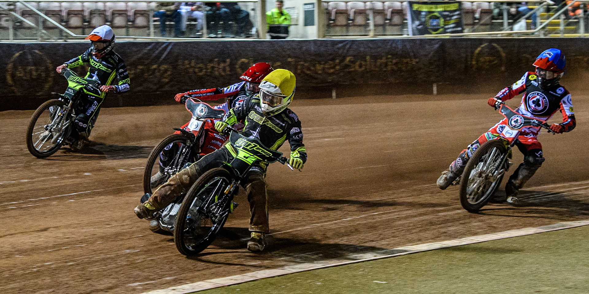 Tom Brennan of Ipswich Witches in Yellow leading Brady Kurtz of Belle Vue Aces in Red, Adam Ellis of Ipswich Witches in White and Tate Zischke of Belle Vue Aces  in Blue during the Premiership Cup Quarter Final 1st Leg match between Belle Vue Aces and Ipswich Witches at the National Speedway Stadium, Manchester on Monday 24th March 2025. (Photo: Ian Charles | MI News)