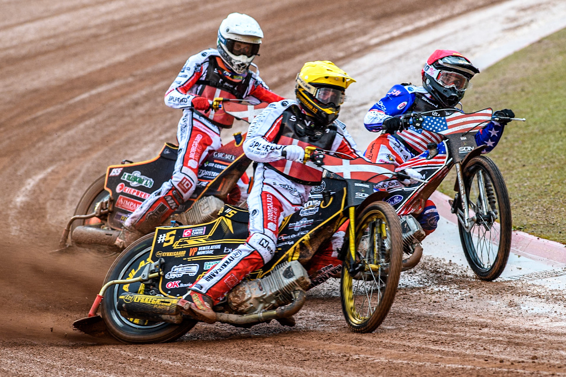 USA v Denmark: Anders Thomsen of Denmark in Yellow rides outside Broc Nicol of the USA in Red with Mikkel Michelsen of Denmark behind during the Monster Energy FIM Speedway of Nation Semi Final 2 at the National Speedway Stadium, Manchester on Wednesday 10th July 2024. (Photo: Ian Charles | MI News)