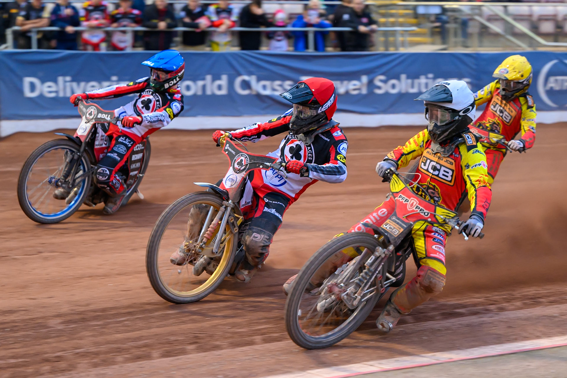 Dan Thompson of Leicester Lions in White rides inside Norick Blödorn of Belle Vue Aces in Red and Brady Kurtz of Belle Vue Aces in Blue with Kyle Howarth of Leicester Lions  in Yellow behind during the Rowe Motor Oil Premiership match between Belle Vue Aces and Leicester Lions at the National Speedway Stadium, Manchester on Monday 15th June 2026. (Photo: Ian Charles | MI News)