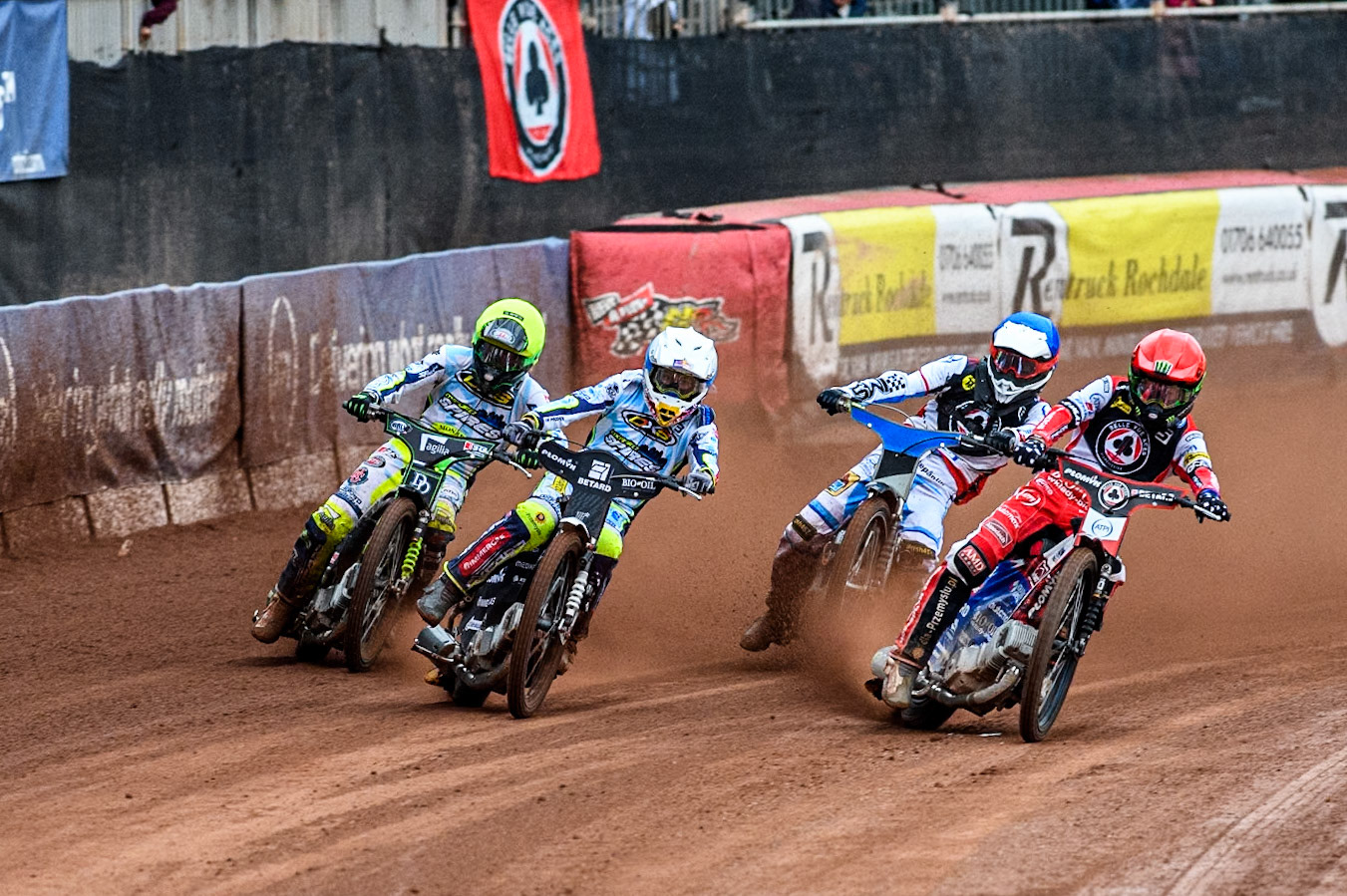 Belle Vue Aces' Dan Bewley  in Red rides inside Oxford Spires' Maciej Janowski in White with Belle Vue Aces' guest Antti Vuolas  in Blue and Oxford Spires' Charles Wright  in Yellow behind during the Rowe Motor Oil Premiership match between Belle Vue Aces and Oxford Spires at the National Speedway Stadium, Manchester on  Monday 22nd July 2024. (Photo: Ian Charles | MI News)