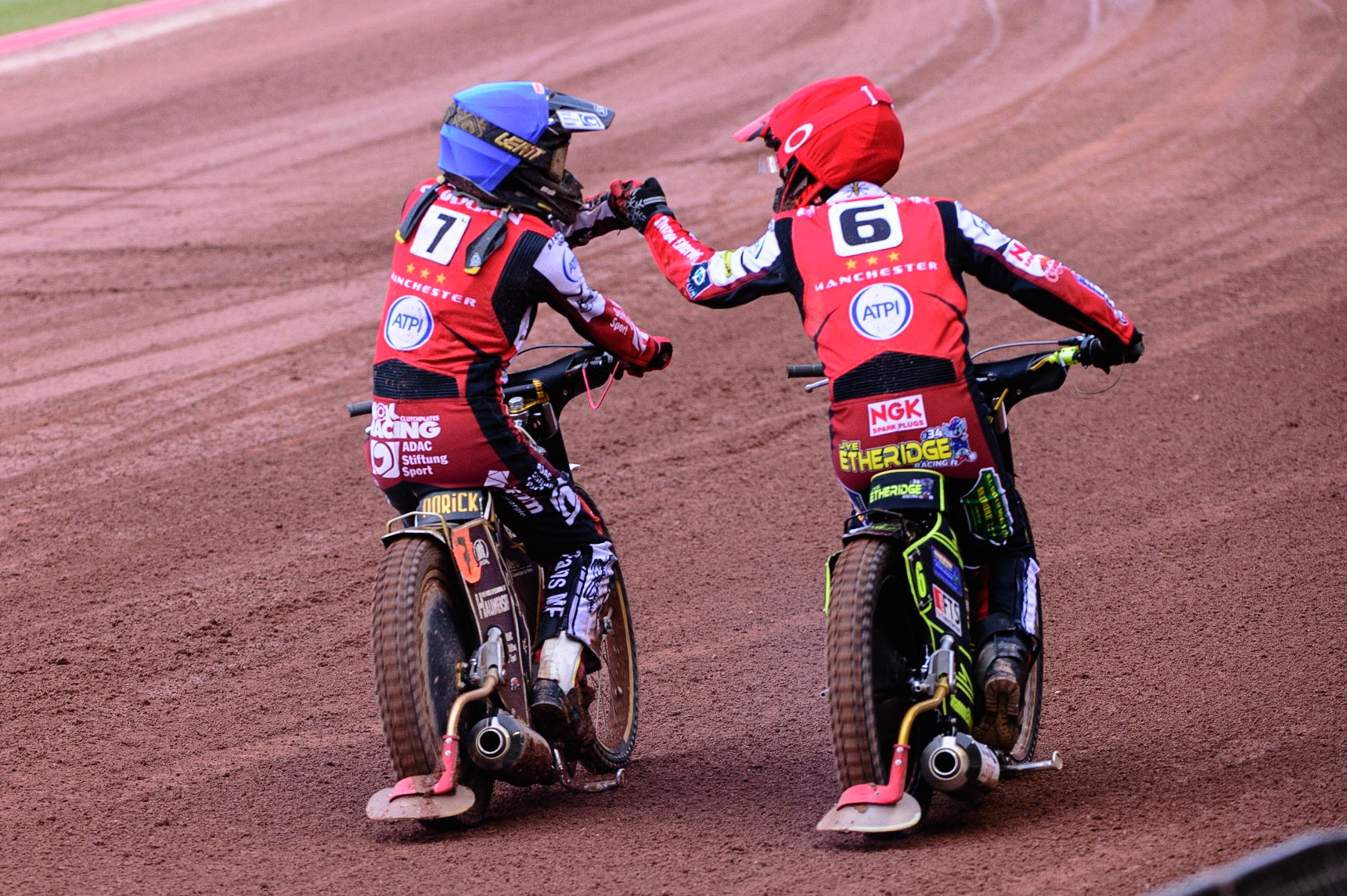 MANCHESTER UK  Norick Blodorn  (Blue) and Jye Etheridge (Red) celebrate their heat win  during the SGB Premiership match between Belle Vue Aces and King's Lynn Stars at the National Speedway Stadium, Manchester on Monday 11th July 2022. (Credit: Ian Charles | MI News)