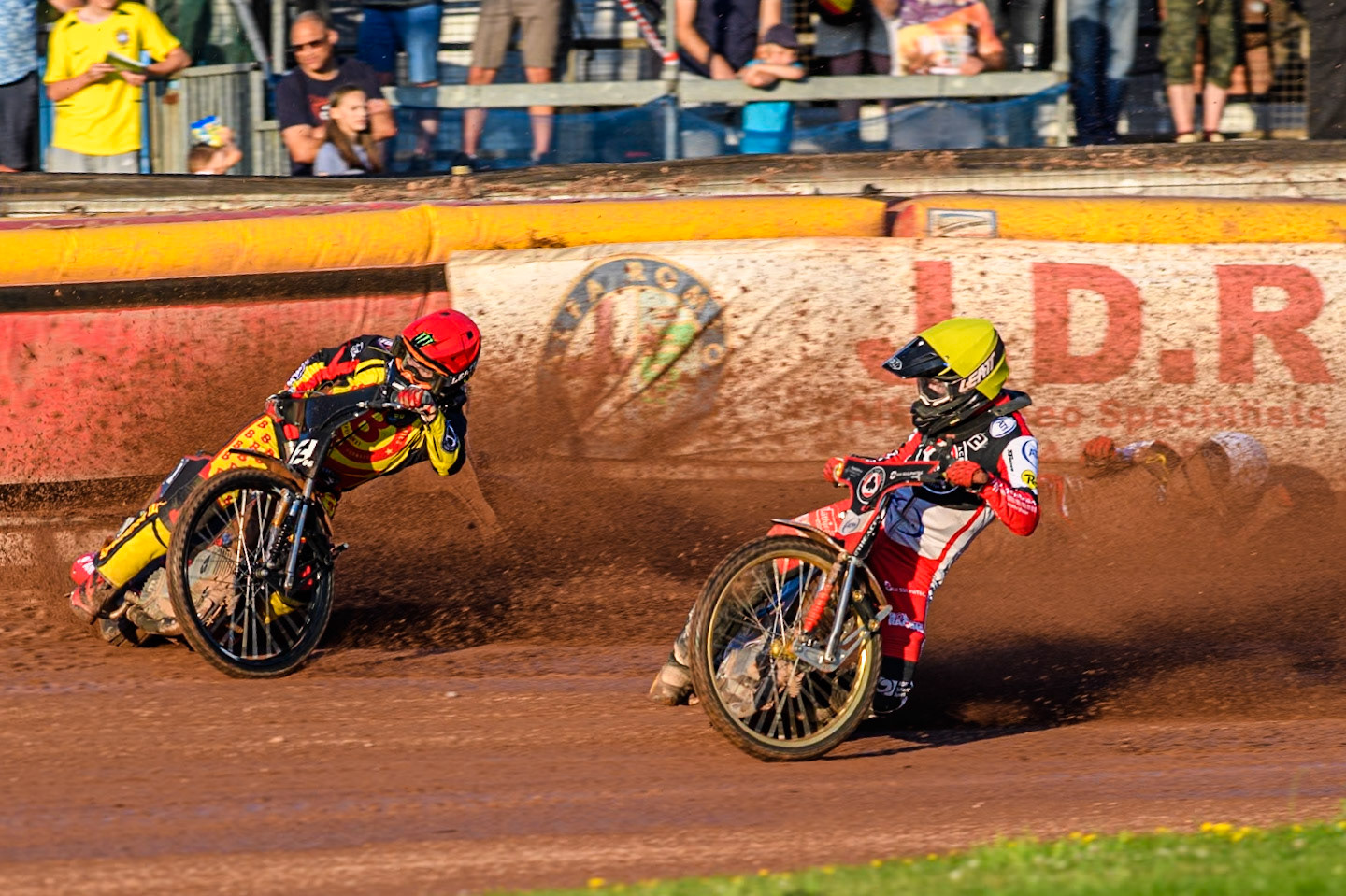 Belle Vue Aces' Brady Kurtz falls on the first turn of the opening lap behind Birmingham Brummies' Freddie Lindgren in Red and Belle Vue Aces' Norick Blodorn in Yellow during the Rowe Motor Oil Premiership match between Birmingham Brummies and Belle Vue Aces at Perry Bar Stadium, Birmingham on Monday 29th July 2024. (Photo: Ian Charles | MI News)