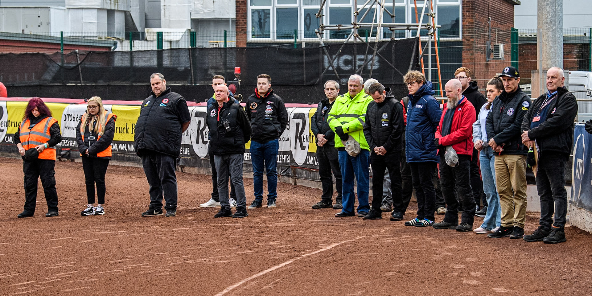 Belle Vue Officials and staff assembled  for the one minute’s silence in memory of  former Belle Vue Speedway announcer Ken Wrench during the Rowe Motor Oil Premiership match between Belle Vue Aces and Ipswich Witches at the National Speedway Stadium, Manchester on Monday 22nd April 2024. (Photo: Ian Charles | MI News)