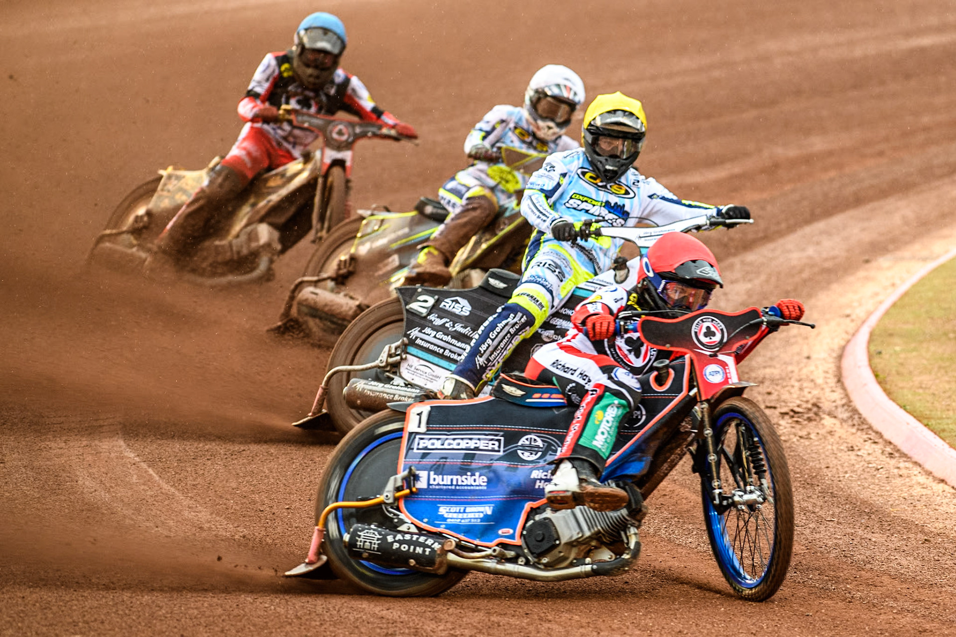 Belle Vue Aces' Brady Kurtz in Red leading Oxford Spires' Erik Riss in Yellow, Oxford Spires' Rohan Tungate in White and Belle Vue Aces' Norick Blodorn in Blue during the Rowe Motor Oil Premiership match between Belle Vue Aces and Oxford Spires at the National Speedway Stadium, Manchester on Monday 13th May 2024. (Photo: Ian Charles | MI News)
