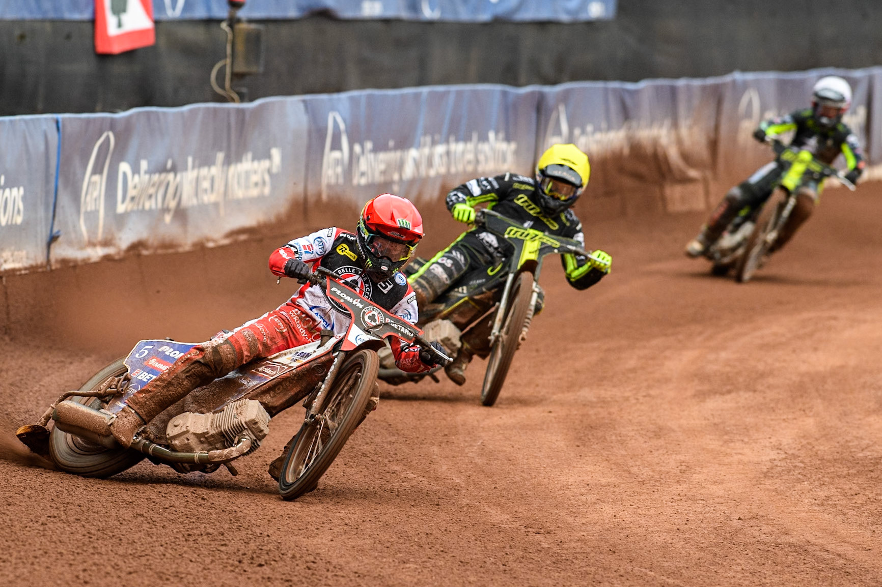 Belle Vue Aces' Dan Bewley  in Red leading Ipswich Witches' Adam Ellis in Yellow and Ipswich Witches' Danny King in White during the Rowe Motor Oil Premiership match between Belle Vue Aces and Ipswich Witches at the National Speedway Stadium, Manchester on Monday 1st July 2024. (Photo: Ian Charles | MI News)