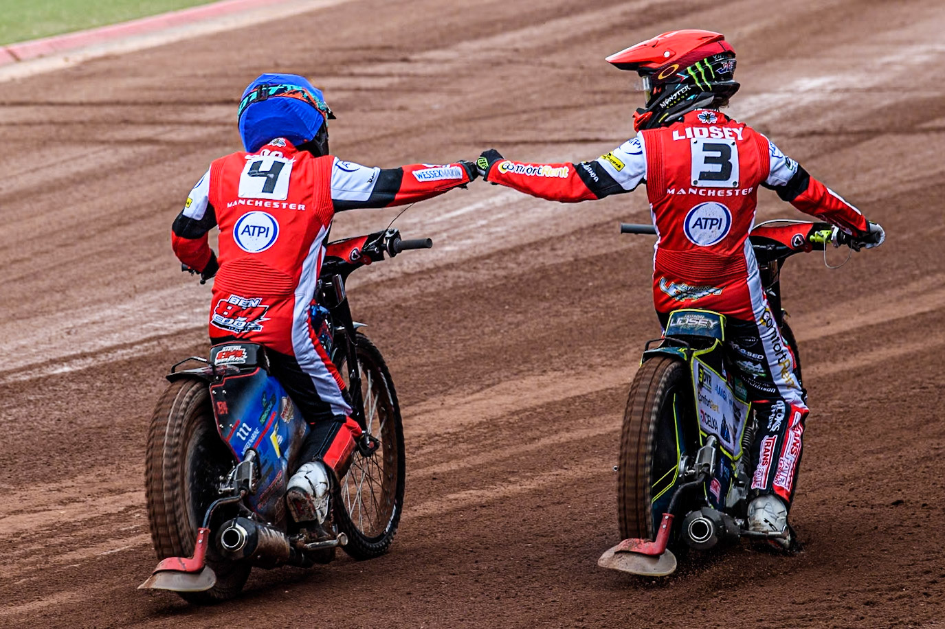 Belle Vue Aces' Jaimon Lidsey  in Red and Belle Vue Aces' Ben Cook  celebrate their maximum points heat win during the Rowe Motor Oil Premiership match between Belle Vue Aces and Birmingham Brummies at the National Speedway Stadium, Manchester on Monday 6th May 2024. (Photo: Ian Charles | MI News)