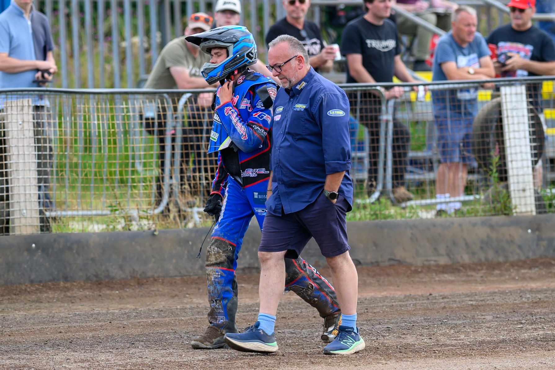 Emerson Betty of Oxford Chargers (Left)  walks back to the pits with Peter Schroeck, Team Manager of Oxford Chargers after his fall in heat 9 during the WSRA National Development League match between Buxton Bulls and Oxford Chargers at Hi-Edge Speedway, Buxton on Sunday 2nd August 2026. (Photo: Ian Charles | MI News)