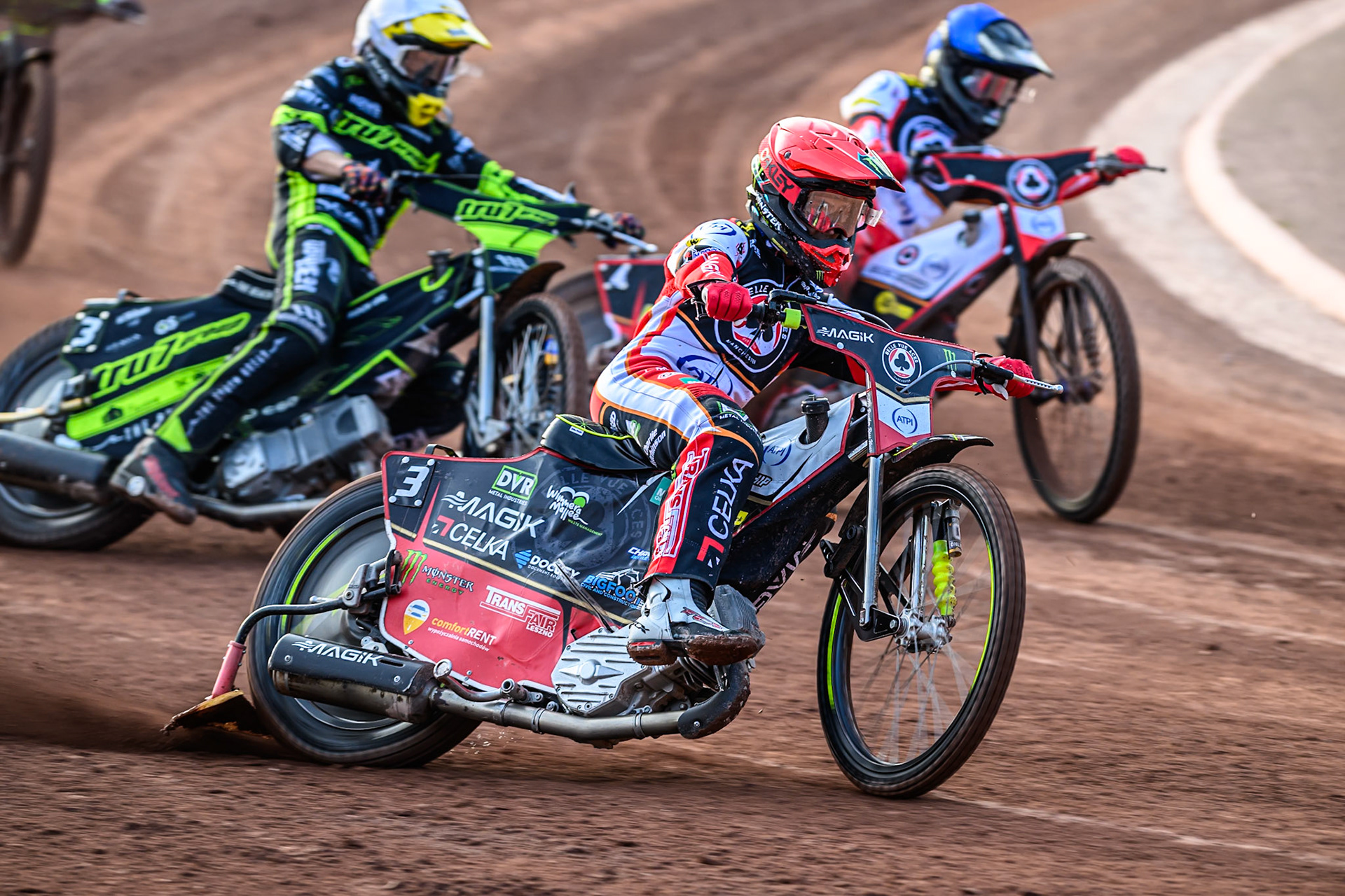 Belle Vue Aces' Jaimon Lidsey  in Red leading Ipswich Witches' Adam Ellis  in White and Belle Vue Aces' Zach Cook  in Blue during the Rowe Motor Oil Premiership match between Belle Vue Aces and Ipswich Witches at the National Speedway Stadium, Manchester on Monday 30th June 2025. (Photo: Ian Charles | MI News)