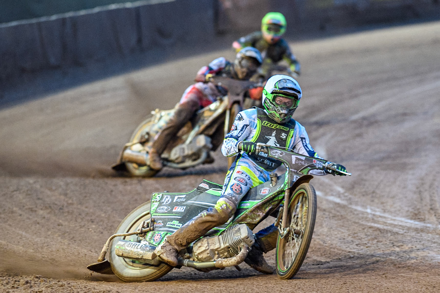 Ipswich Witches' Guest Charles Wright in White leading Belle Vue Aces' Norick Blödorn in Blue and Ipswich Witches' Keynan Rew in Yellow during the Rowe Motor Oil Premiership match between Belle Vue Aces and Ipswich Witches at the National Speedway Stadium, Manchester on Monday 22nd April 2024. (Photo: Ian Charles | MI News)