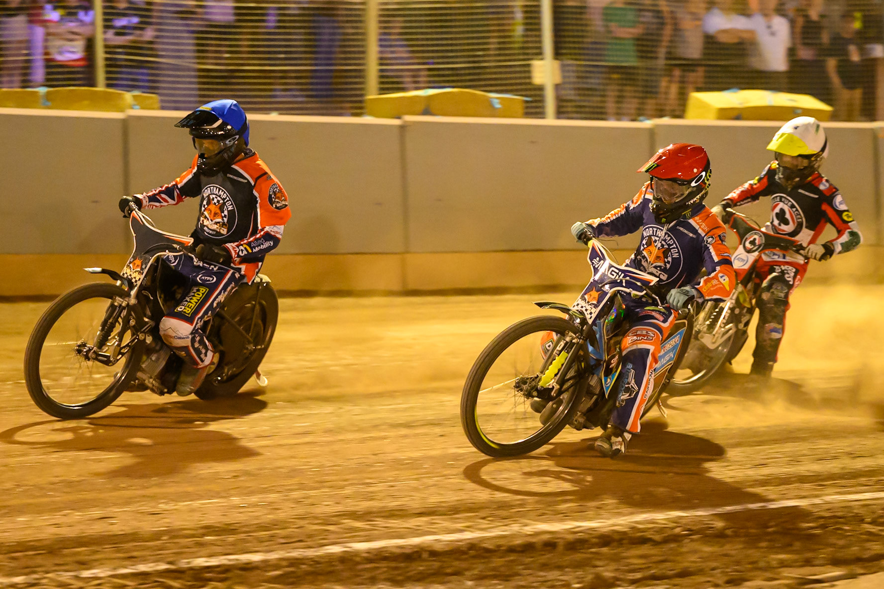 Adam Ellis of Northampton Foxes  in Blue  and Jaimon Lidsey of Northampton Foxes  in Red leading Norick Blodorn of Belle Vue Aces  in Yellow during the Rowe Motor Oil Premiership match between Northampton Foxes and Belle Vue Aces at Northampton International Shaleway, Northampton on Thursday 13th August 2026. (Photo: Ian Charles | MI News)