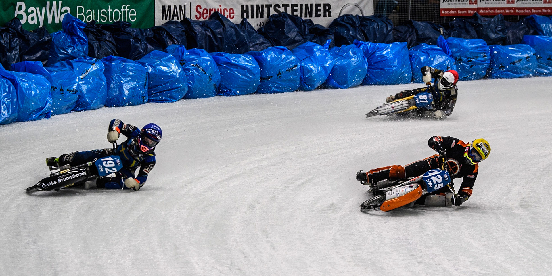 Sebastian Reitsma (125) of The Netherlands in Yellow rides inside Niclas Svensson (192) of Sweden in Blue with Jimmy Olsén (81) of Sweden in Red behind during the Ice Speedway Gladiators World Championship Final 1 at Max-Aicher-Arena, Inzell on Saturday 15th March 2025. (Photo: Ian Charles | MI News)