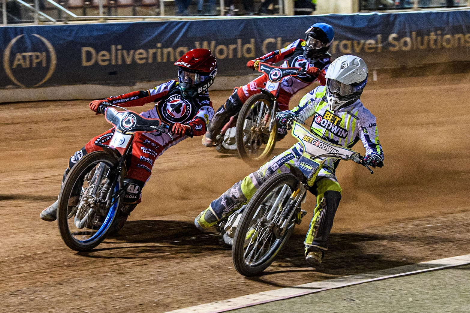 Belle Vue Aces' Brady Kurtz in Red rides outside Oxford Spires' Rohan Tungate in White with Belle Vue Aces' Norick Blodorn in Blue behind during the Rowe Motor Oil Premiership match between Belle Vue Aces and Oxford Spires at the National Speedway Stadium, Manchester on Monday 14th April 2025. (Photo: Ian Charles | MI News)