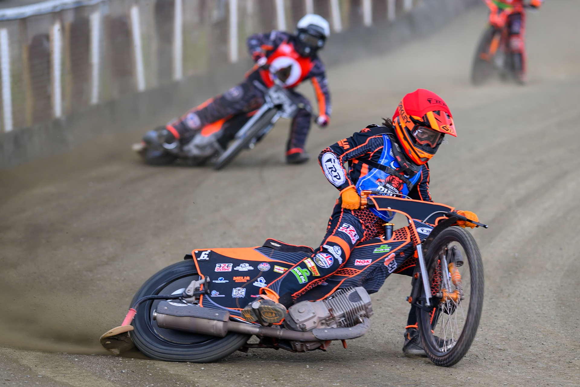 Jack Smith of Buxton Bulls   in Red leading Jack Roberts of NDL Nomads  in White during the  Challenge match between Buxton Bulls and NDL Nomads at Hi-Edge Speedway, Buxton on Sunday 19th April 2026. (Photo: Ian Charles | MI News)