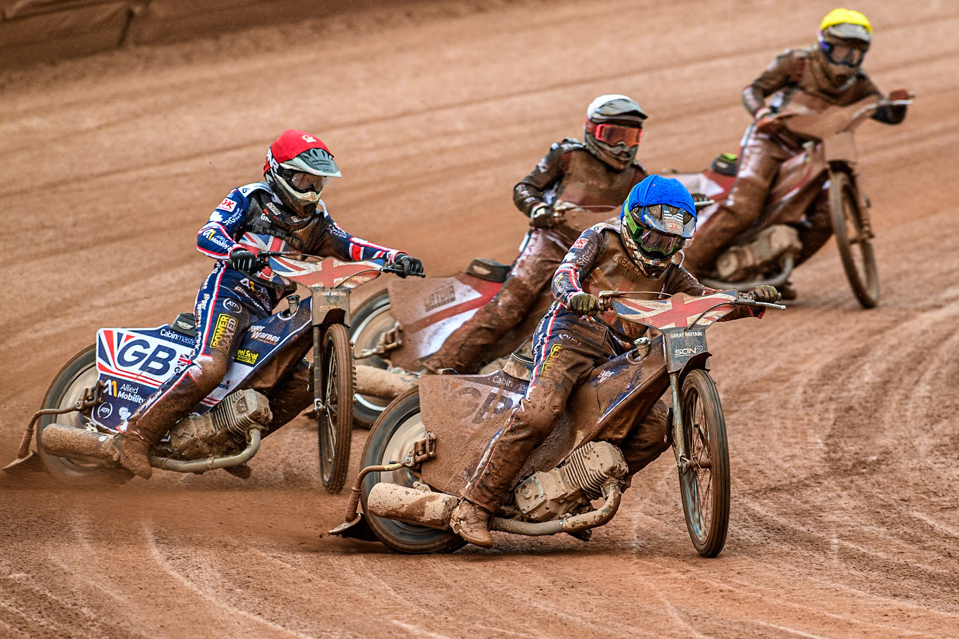 Leon Flint of Great Britain in Blue leading Dan Thompson of Great Britain in Red, Nikita Kaulins of Latvia in White and Artjoms Juhno of Latvia in Yellow  during the Monster Energy FIM Speedway of Nations 2 (Under 21) Final at the National Speedway Stadium, Manchester on Friday 12th July 2024. (Photo: Ian Charles | MI News)