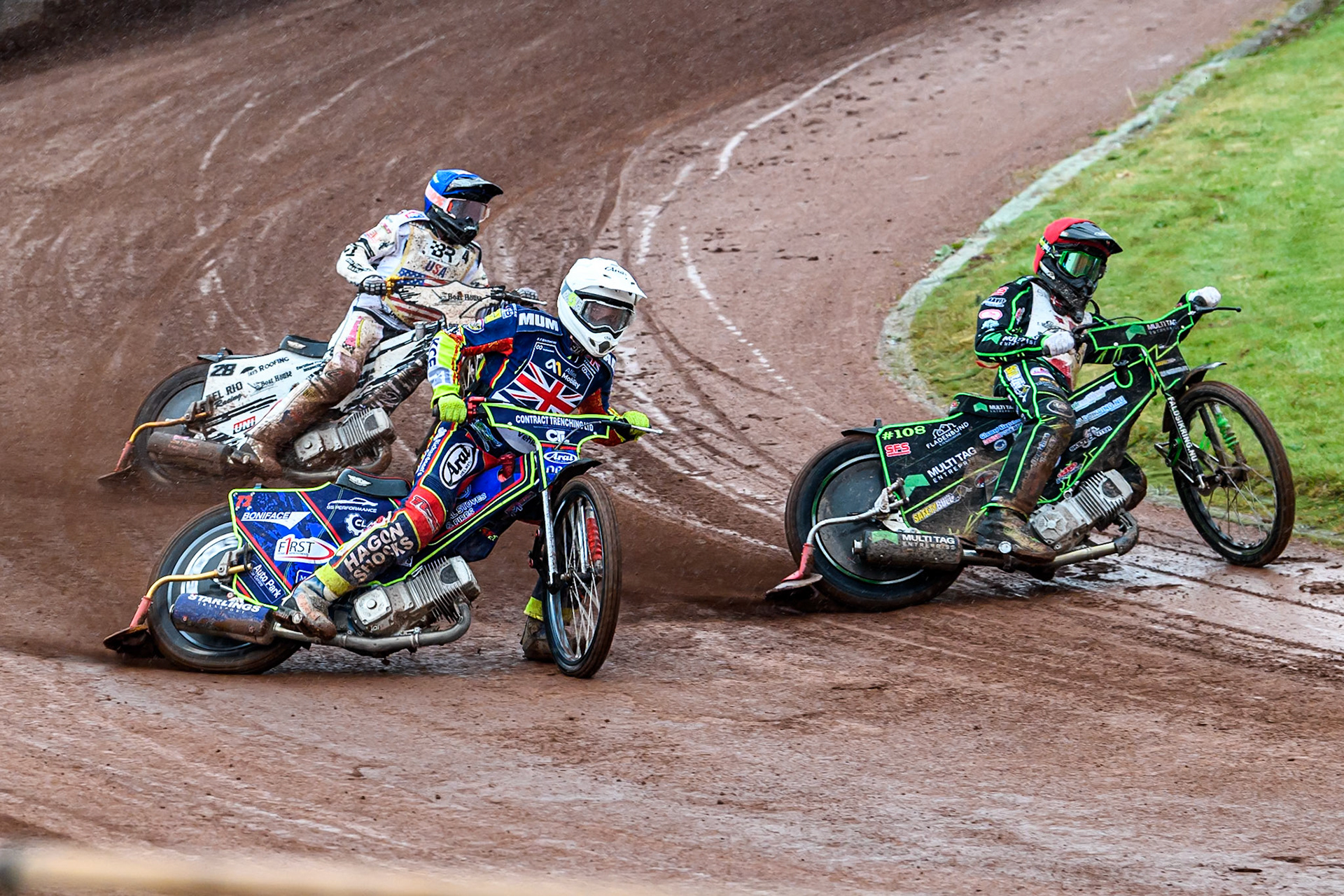 Villads Nagel of Denmark in Red rides inside Jake Mulford of Great Britain in White with Slater Lightcap of The United States in Blue behind during the FIM SGP2 Qualifying Round at the Peugeot Ashfield Stadium in Glasgow on Saturday 24th May 2025. (Photo: Ian Charles | MI News)