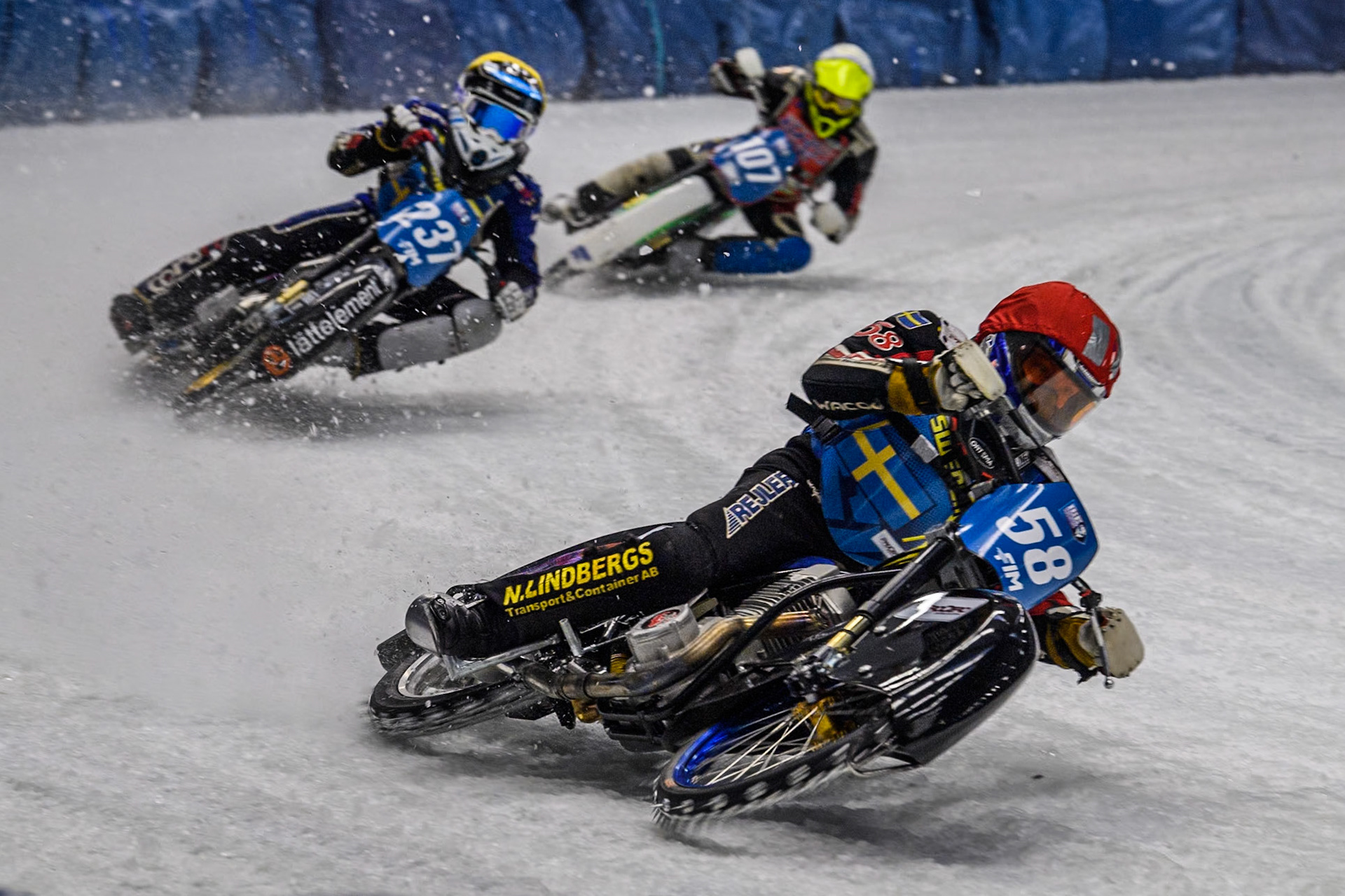 Sweden's Stefan Svensson (58) (Red) leads  Sweden's Jimmy Hörnell Lidfalk (237) (Yellow) and Czech Republic's Andrej Diviš (107) (White) during the FIM Ice Speedway Gladiators World Championship Final 2 at the Max-Aicher-Arena, Inzell on Sunday 24 March 2024. (Photo: Ian Charles | MI News)