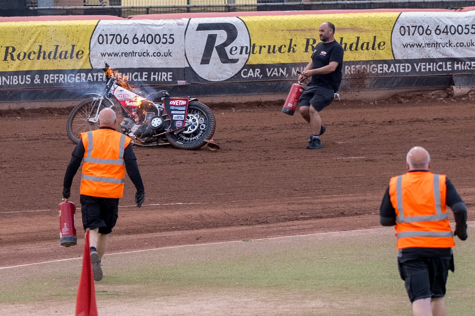 Track staff run towards the burning bike on the track during the Rowe Motor Oil Premiership match between Belle Vue Aces and King's Lynn Stars at the National Speedway Stadium, Manchester on Monday 29th June 2026. (Photo: Ian Charles | MI News)